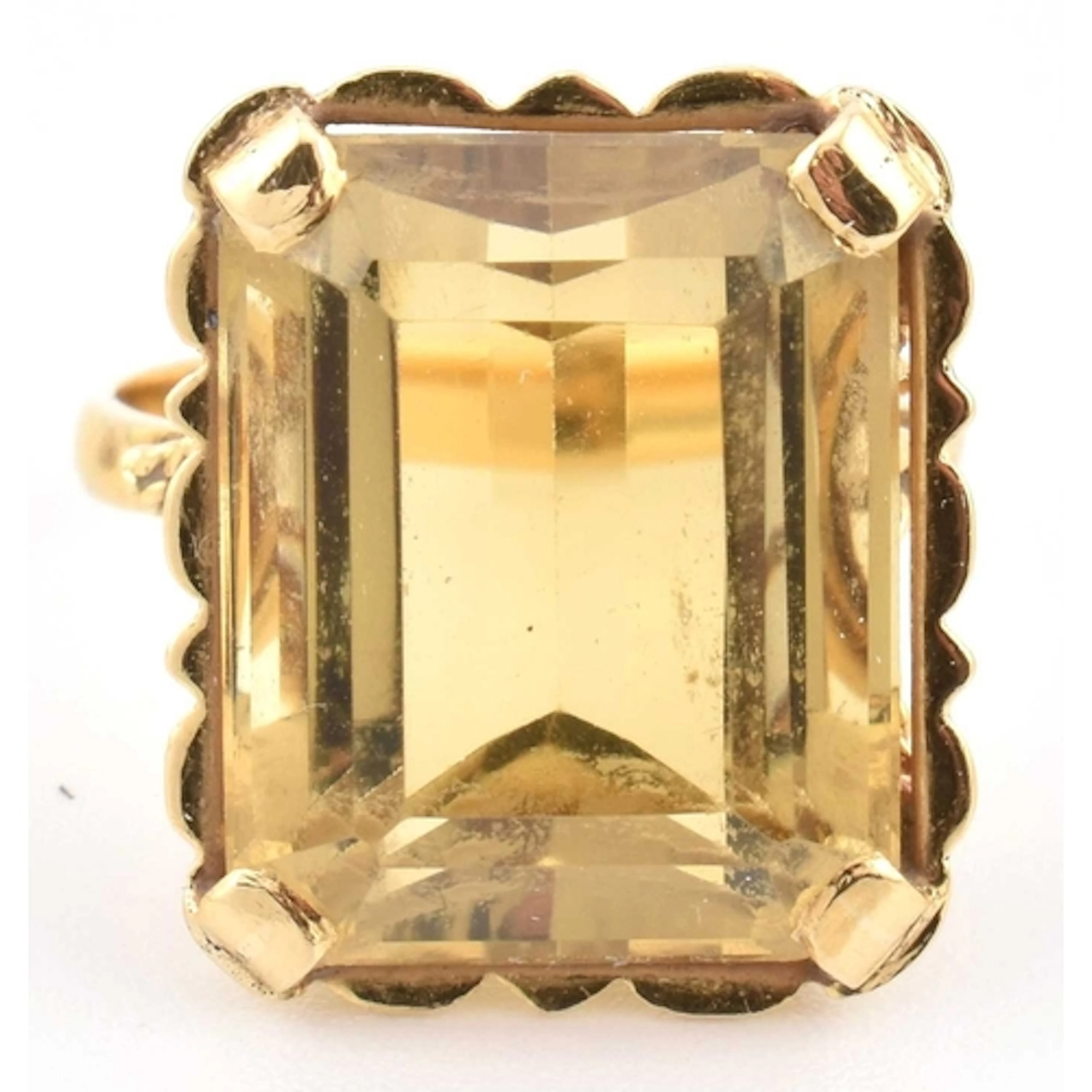 A gold and citrine dress ring. The ring set with an emerald ...