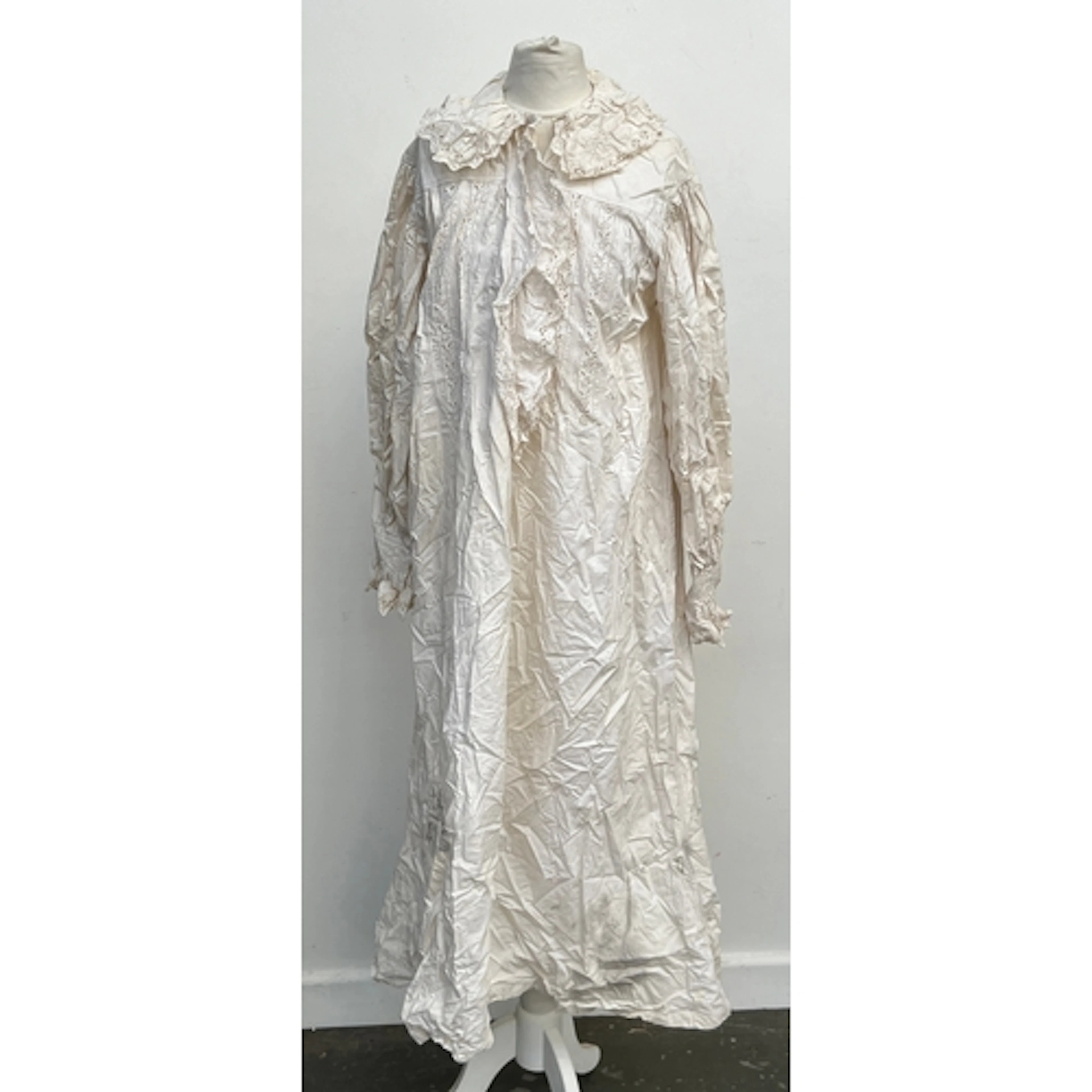 An early 20th century cotton night dress with lace detail