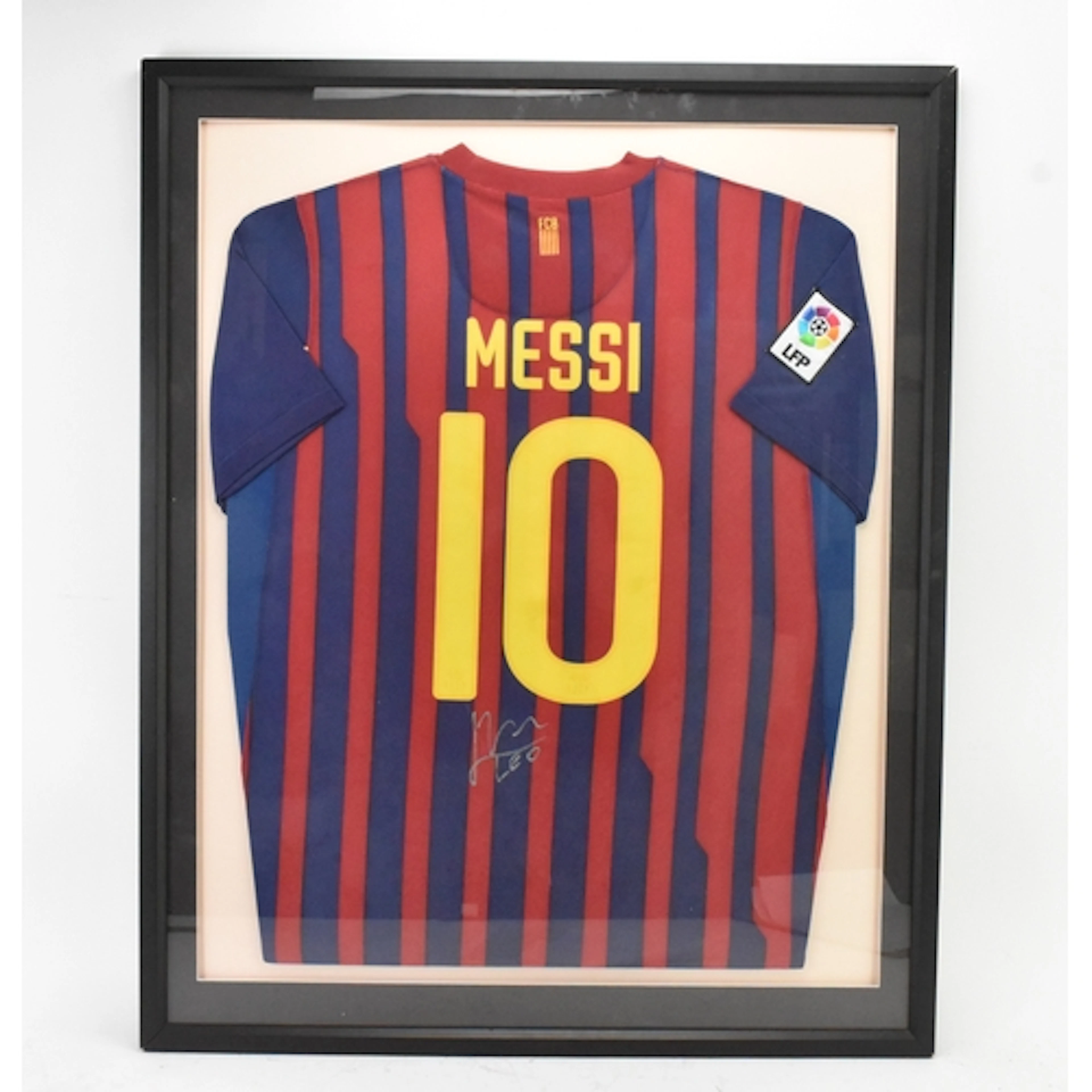 A signed Lionel Messi Barcelona football shirt, framed with ...