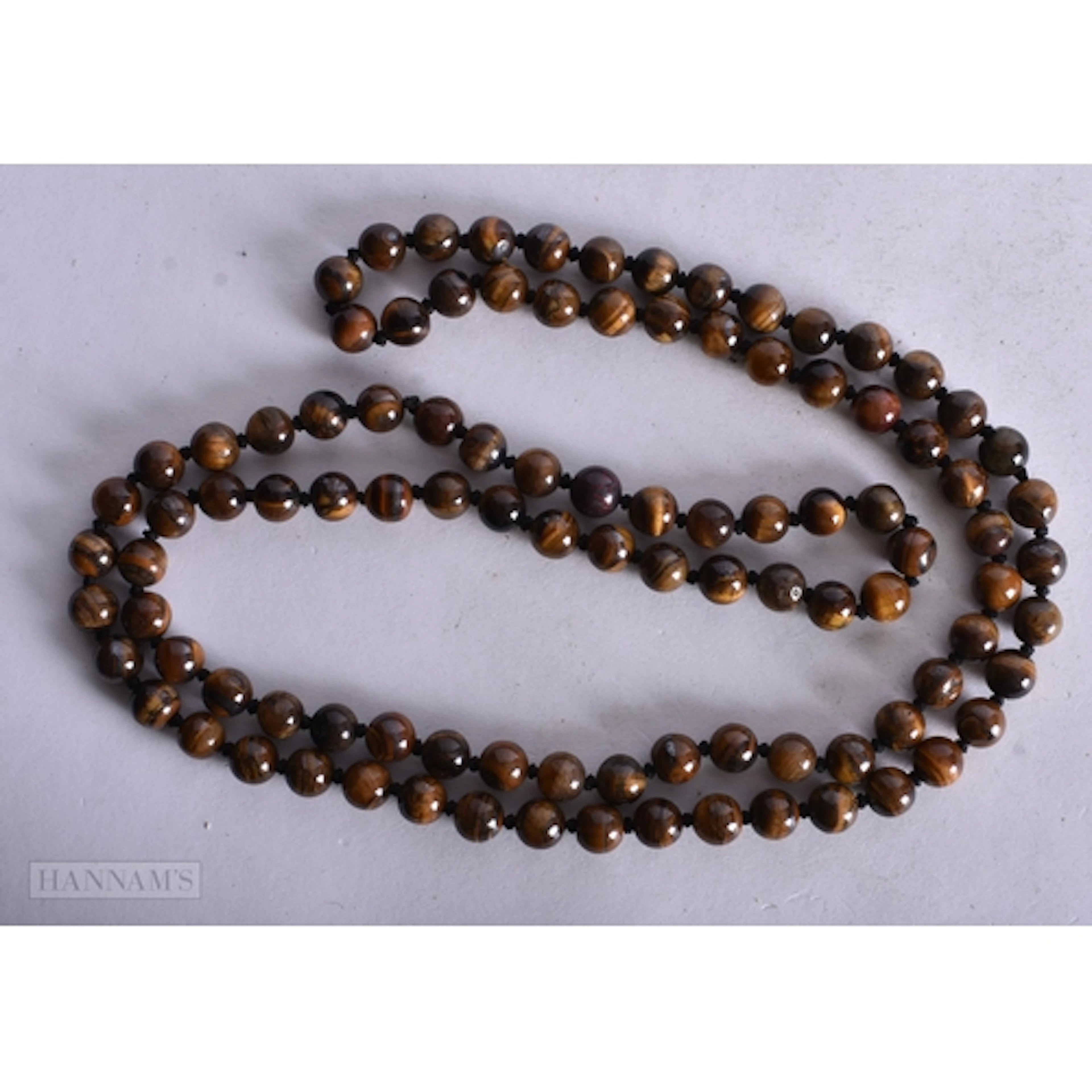 A TIGERS EYE STRING BEAD NECKLACE. 96 cm