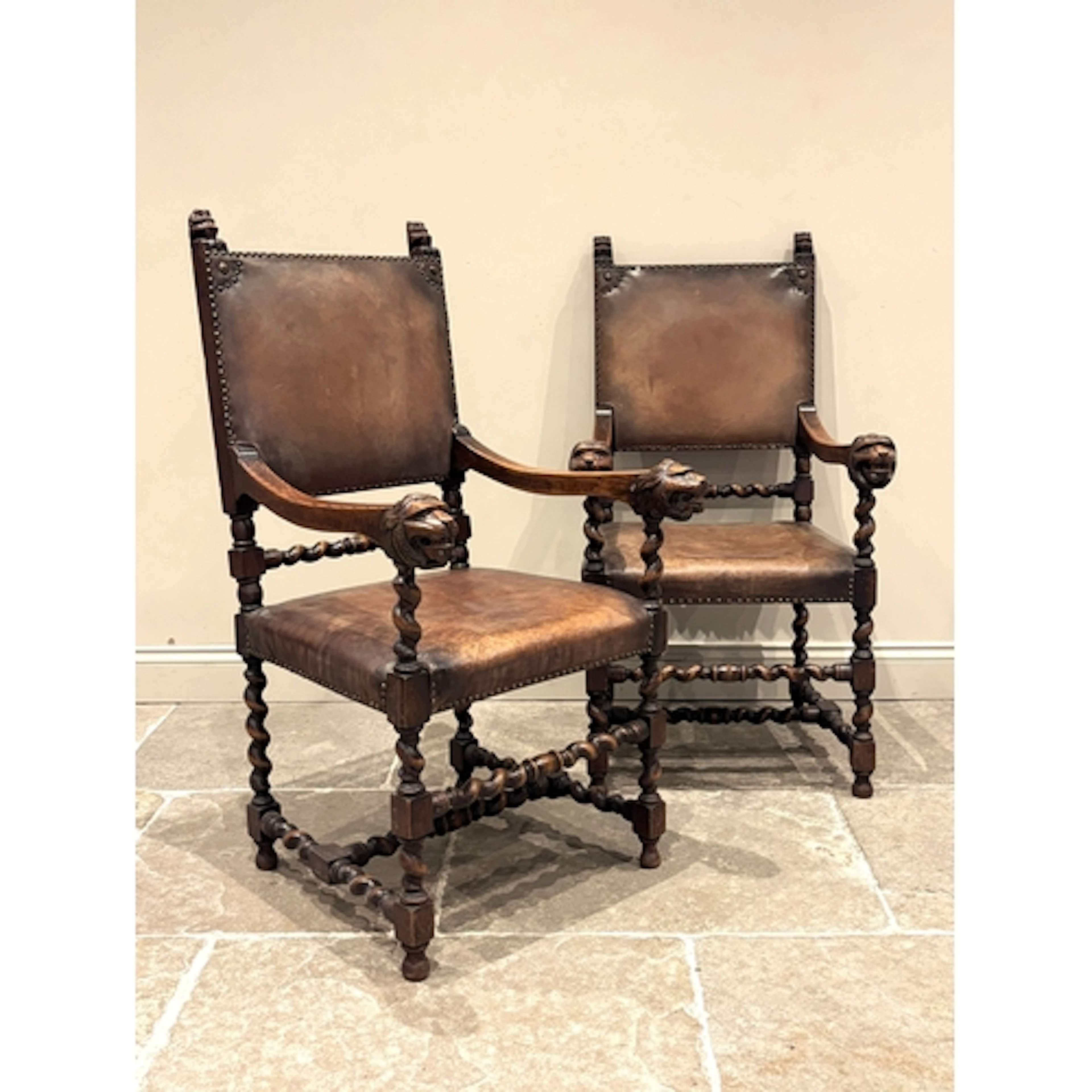 A pair of Carolean style oak hall chairs, 19th century, each...