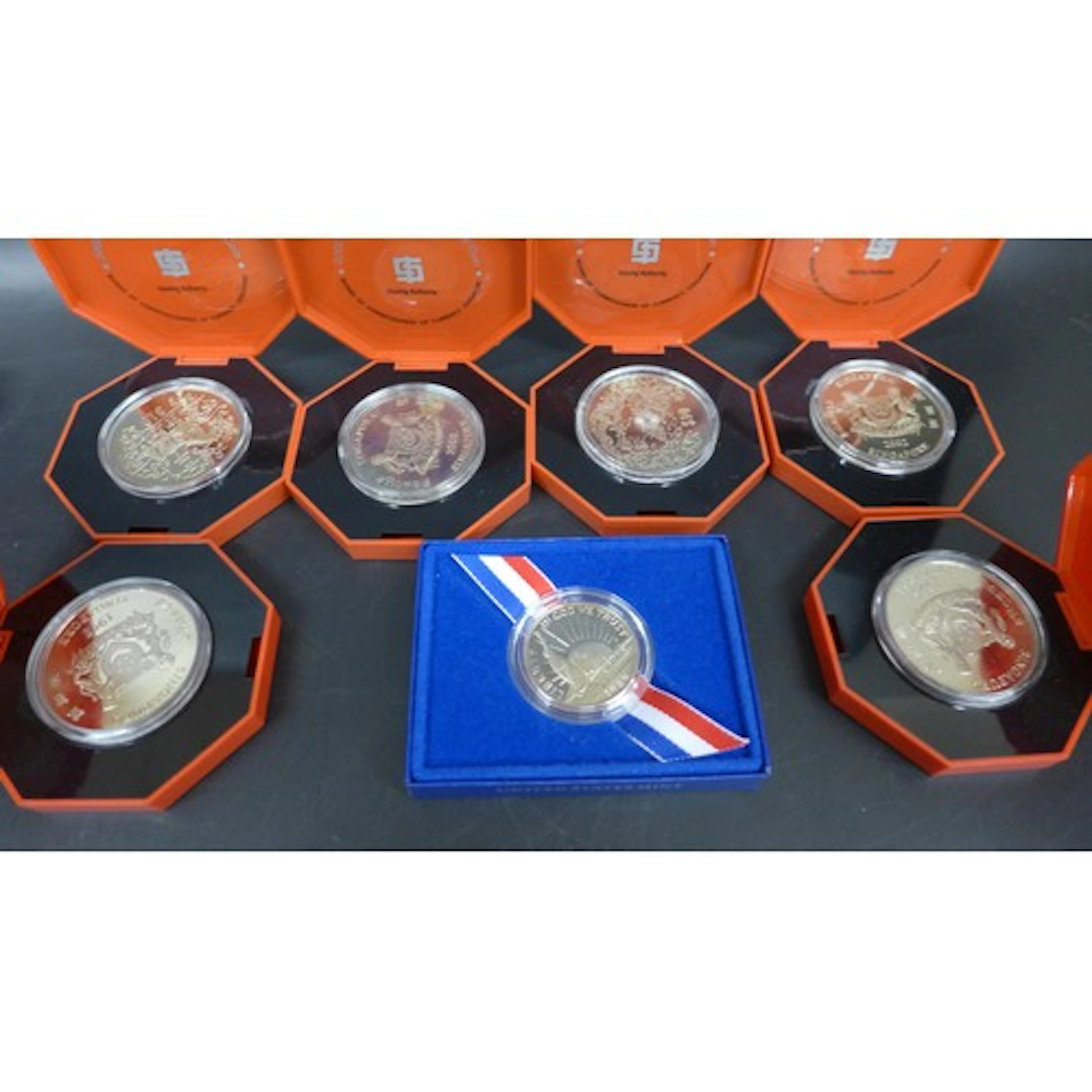 Six Singapore commemorative coins and one 1986 US half-dolla...