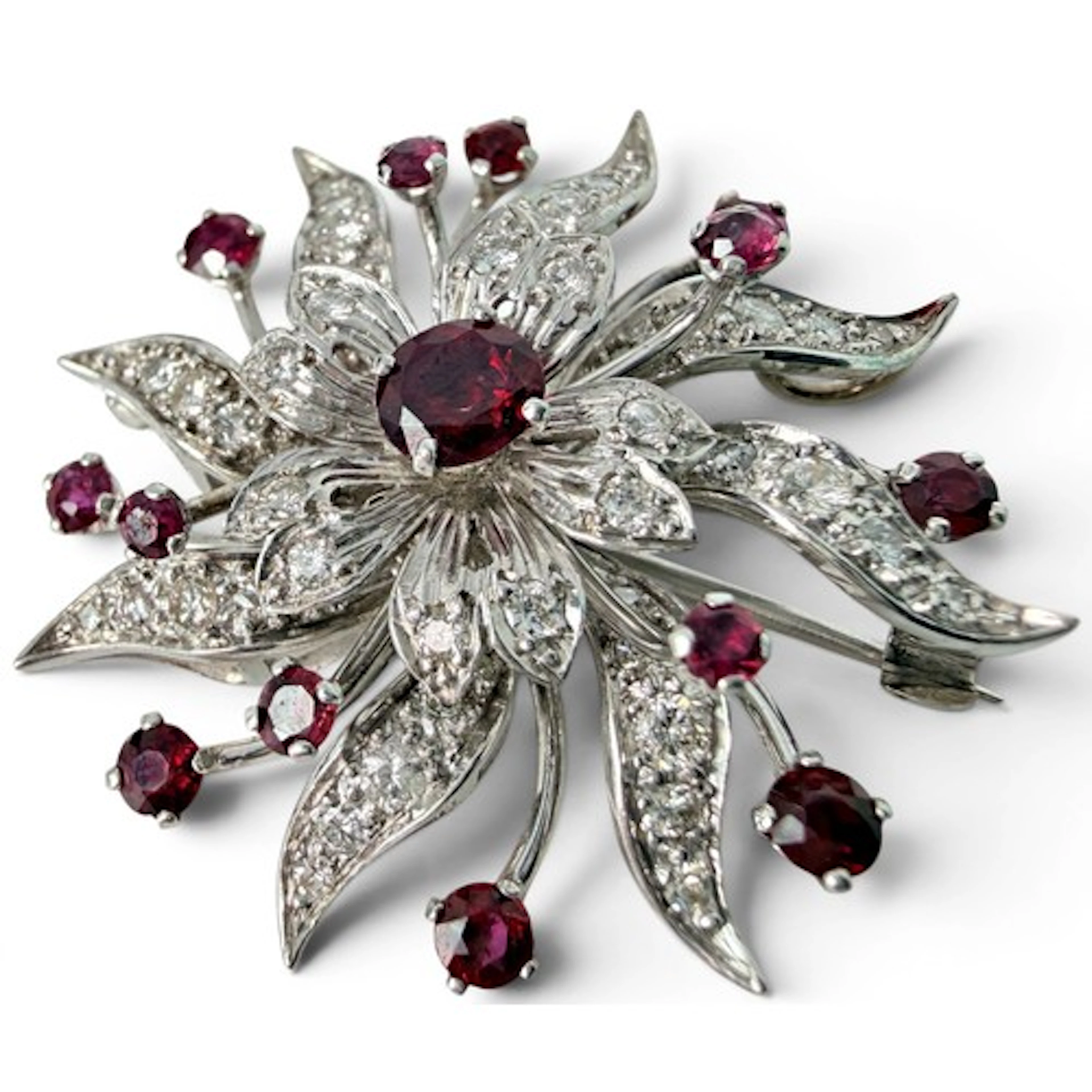 A diamond and ruby floral cluster brooch, set with fourteen ...