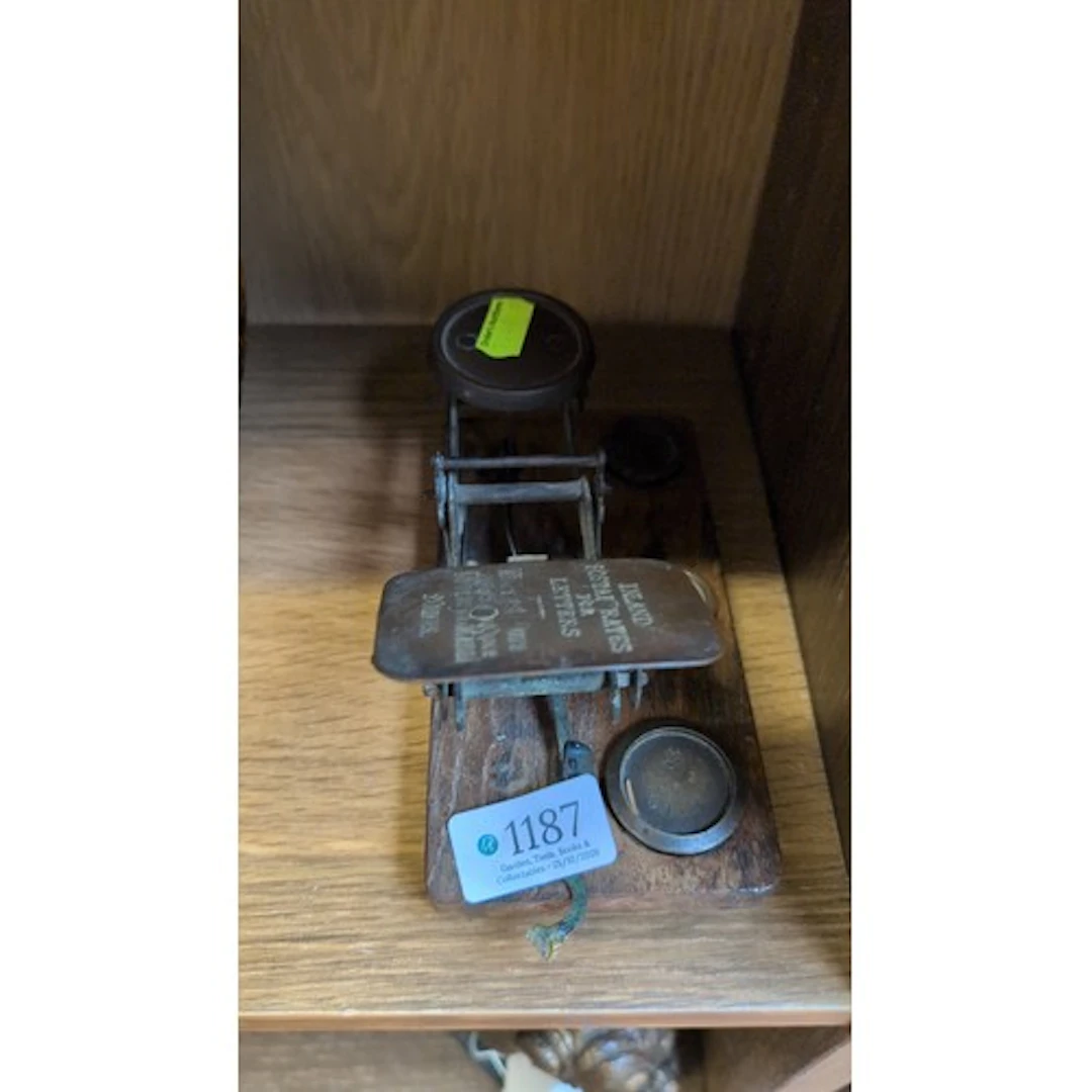 Postal letter balance with metal pans on a rectangular woode...