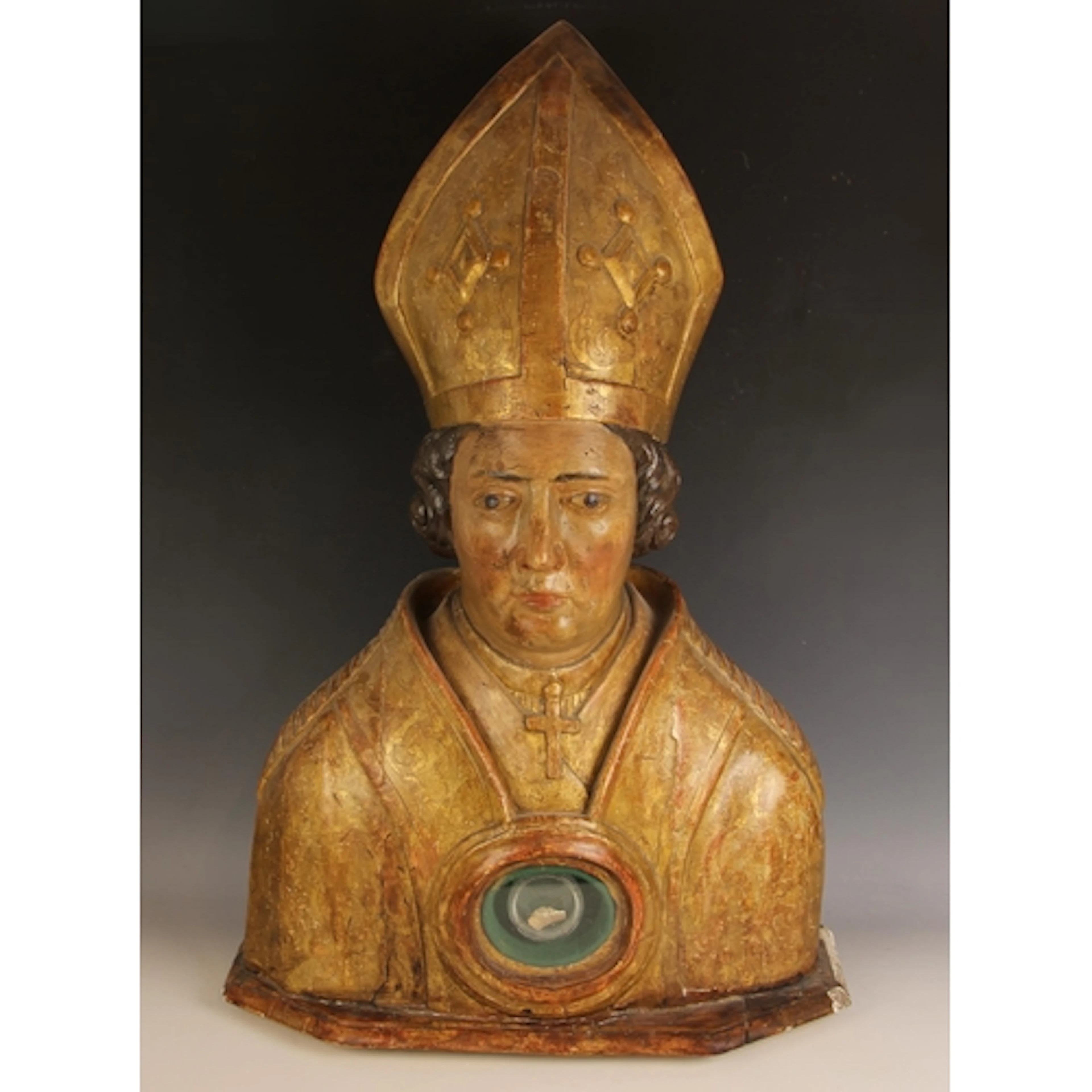 A carved and gilded limewood and gesso reliquary bust, belie...