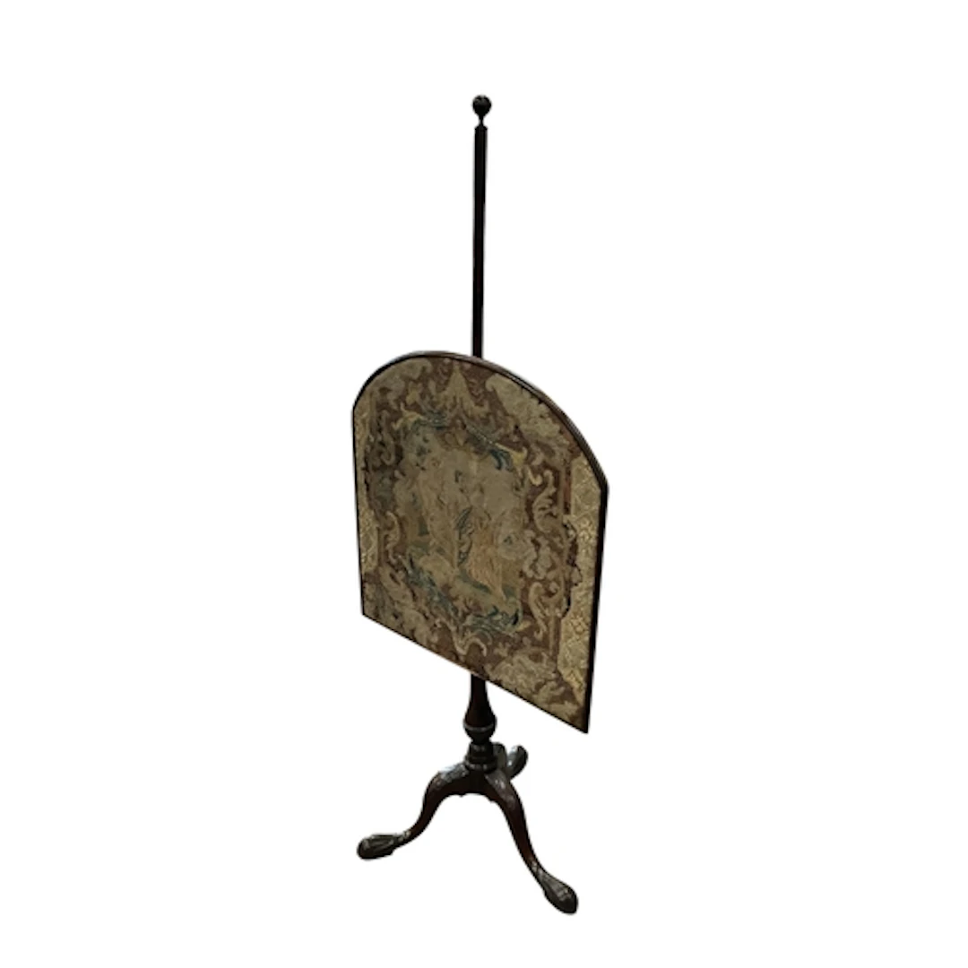 A George III mahogany tripod pole screen with 18th century t...
