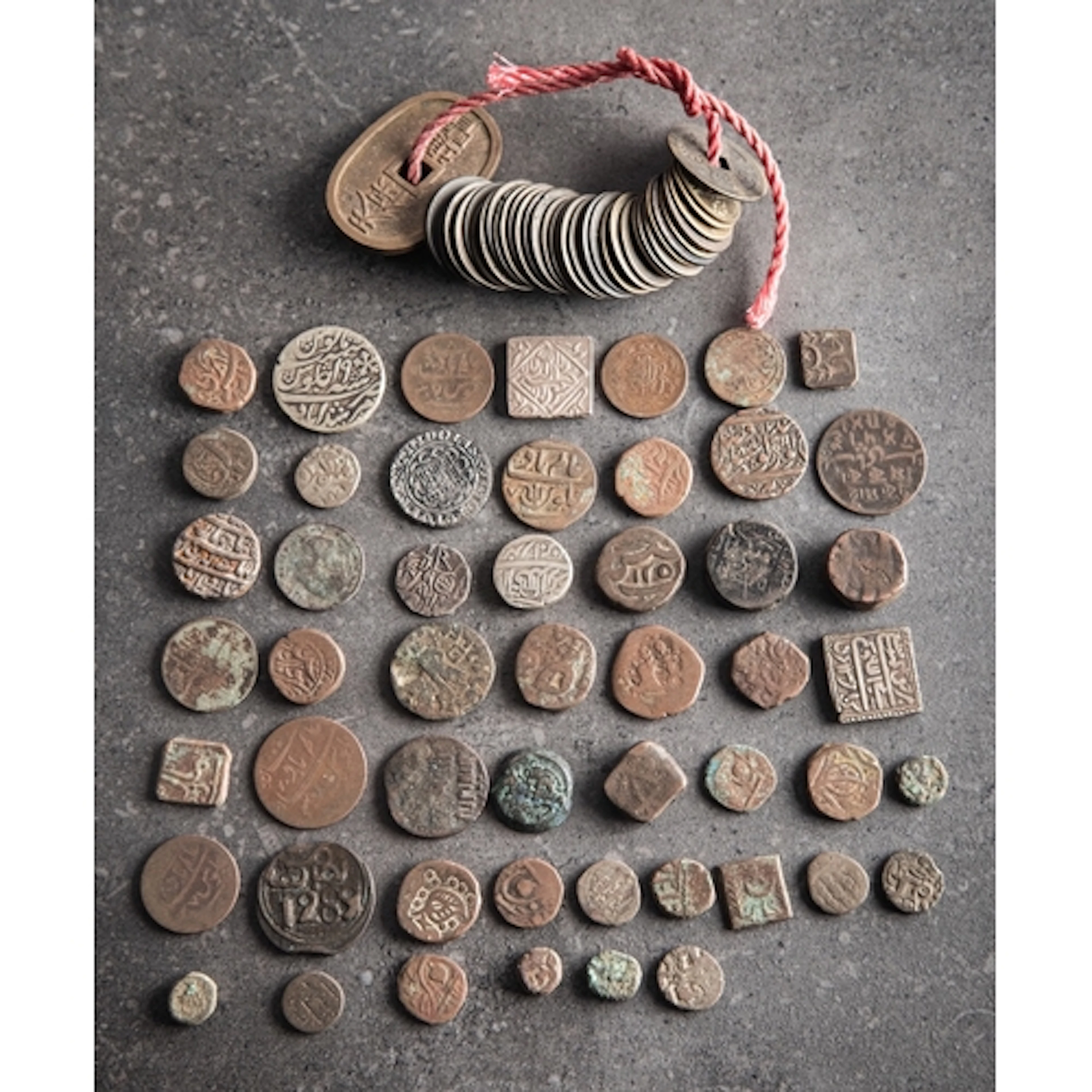 A string of Chinese cash pieces. Together with a Japanese 10...