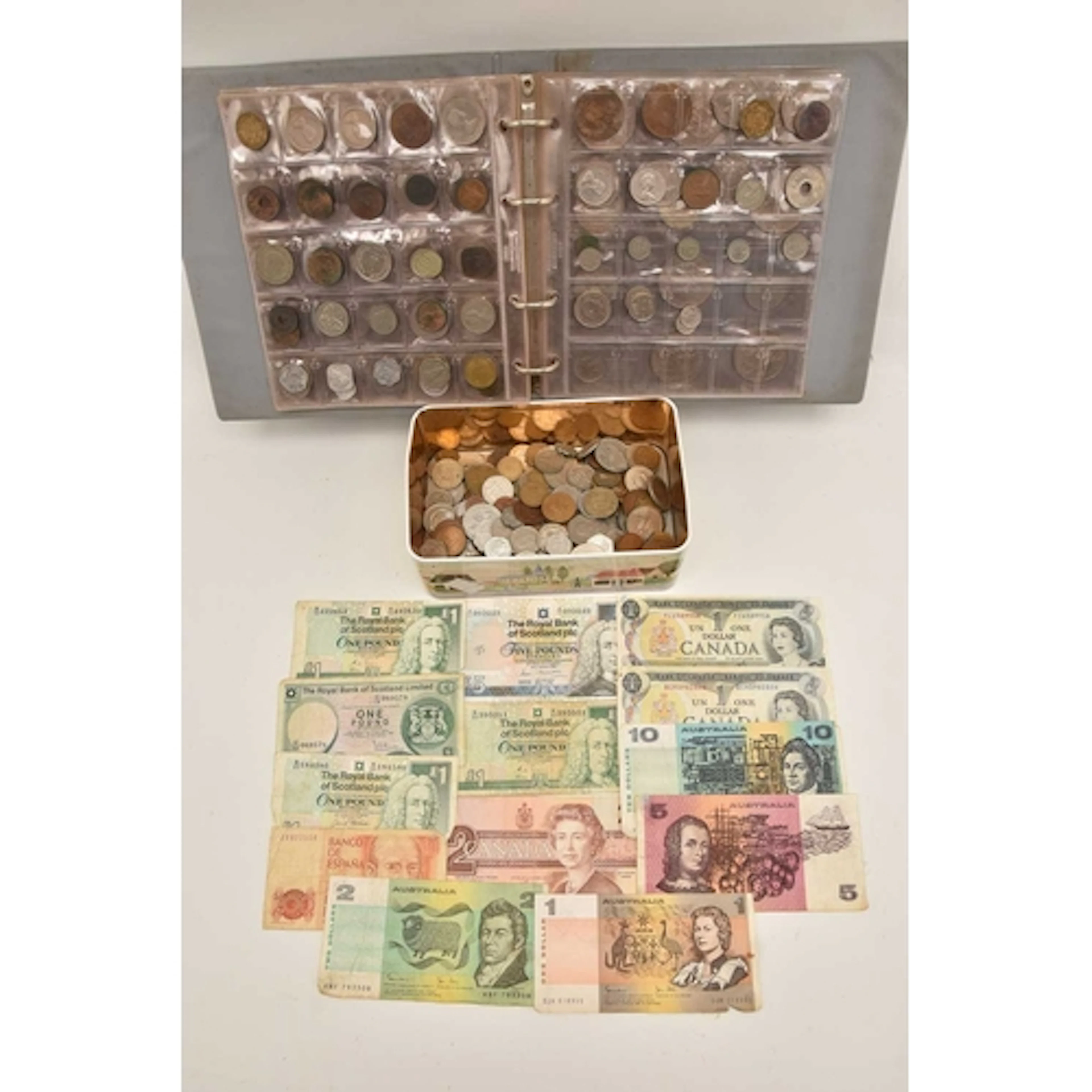 FOLDER AND TIN COINS/NOTES, A lot containing a tin and a coi...