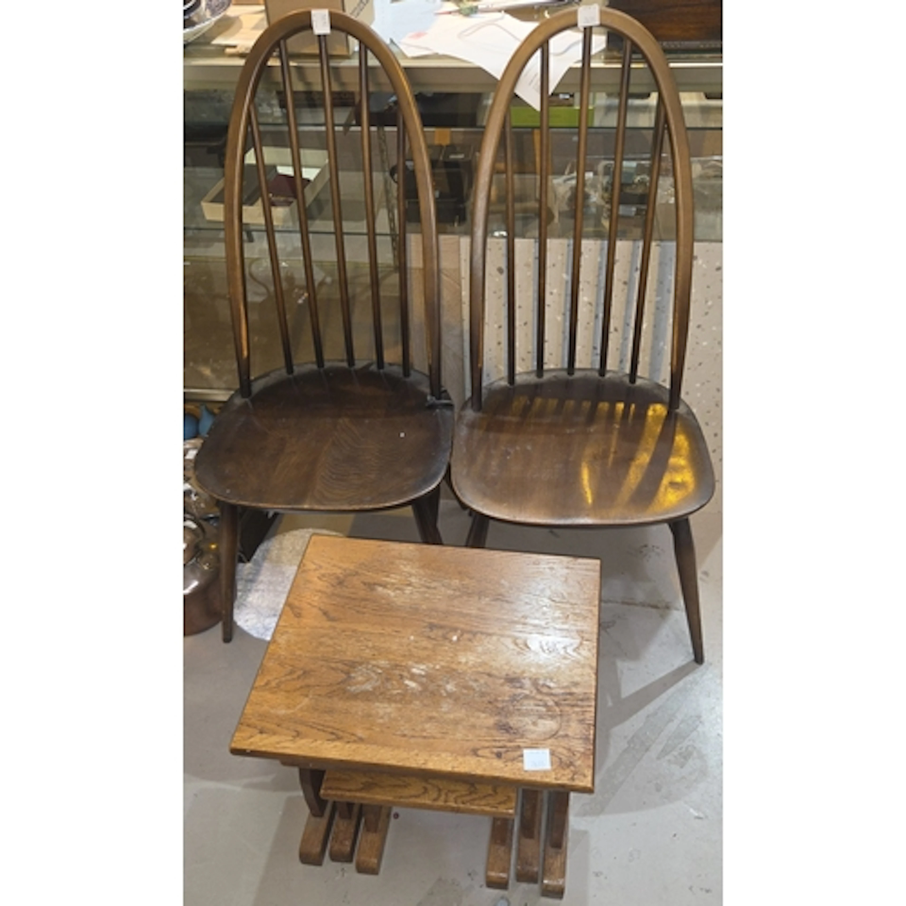 A pair of hoop back Ercol Quaker chairs and an oak nest of t...