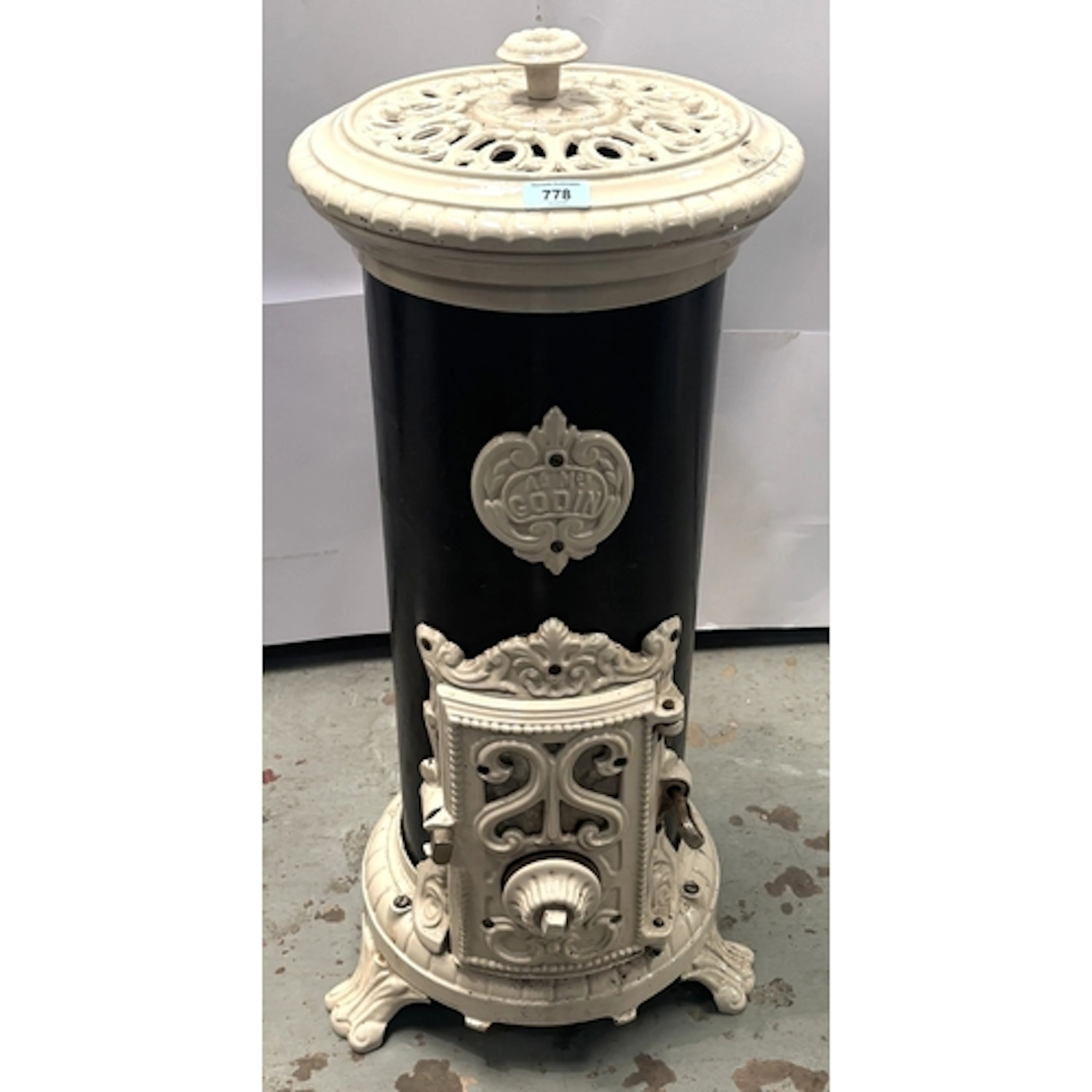 A Godin 19th century cast ion wood burning stove, 81cm high.