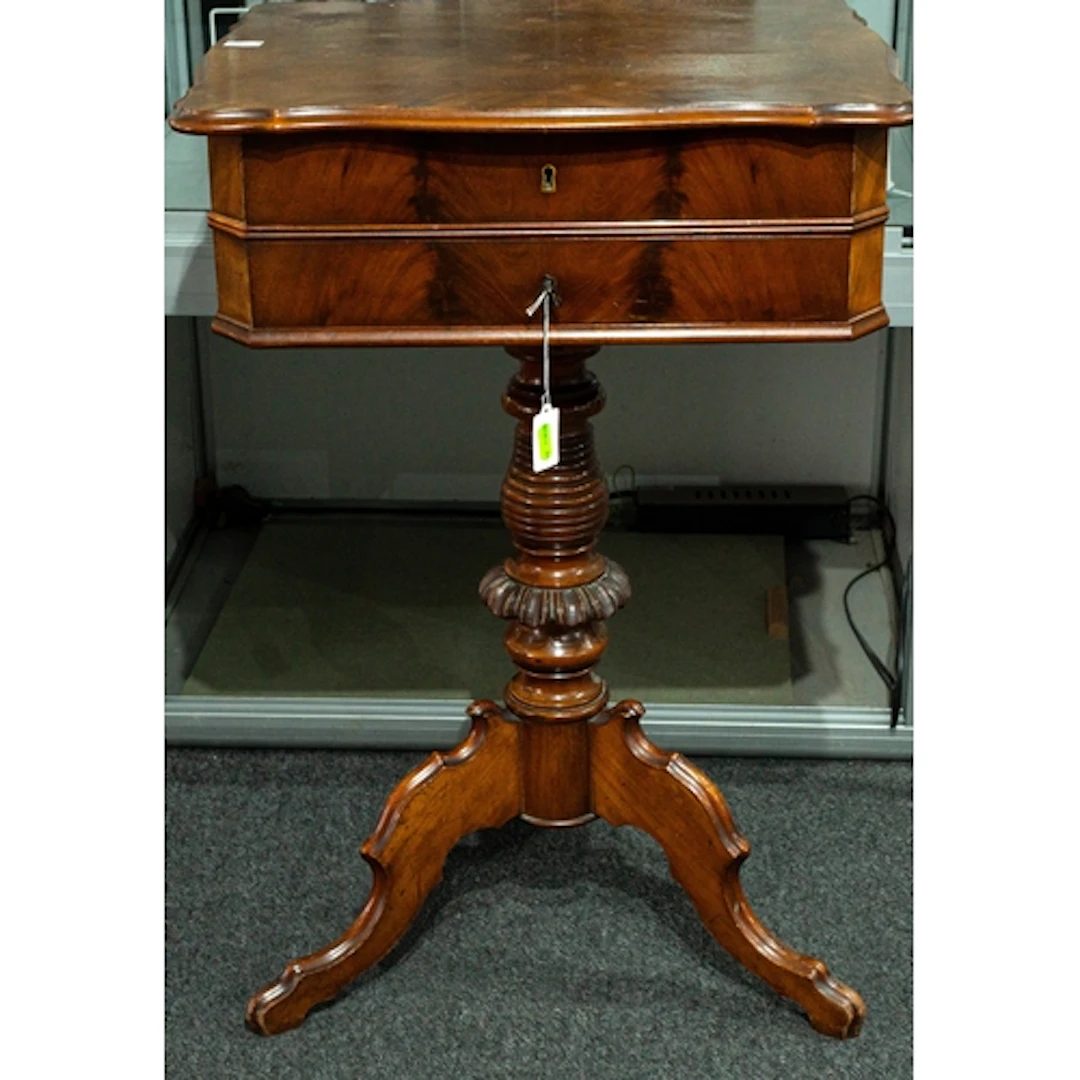 Furniture: a 19th century walnut sewing table, with turned c...