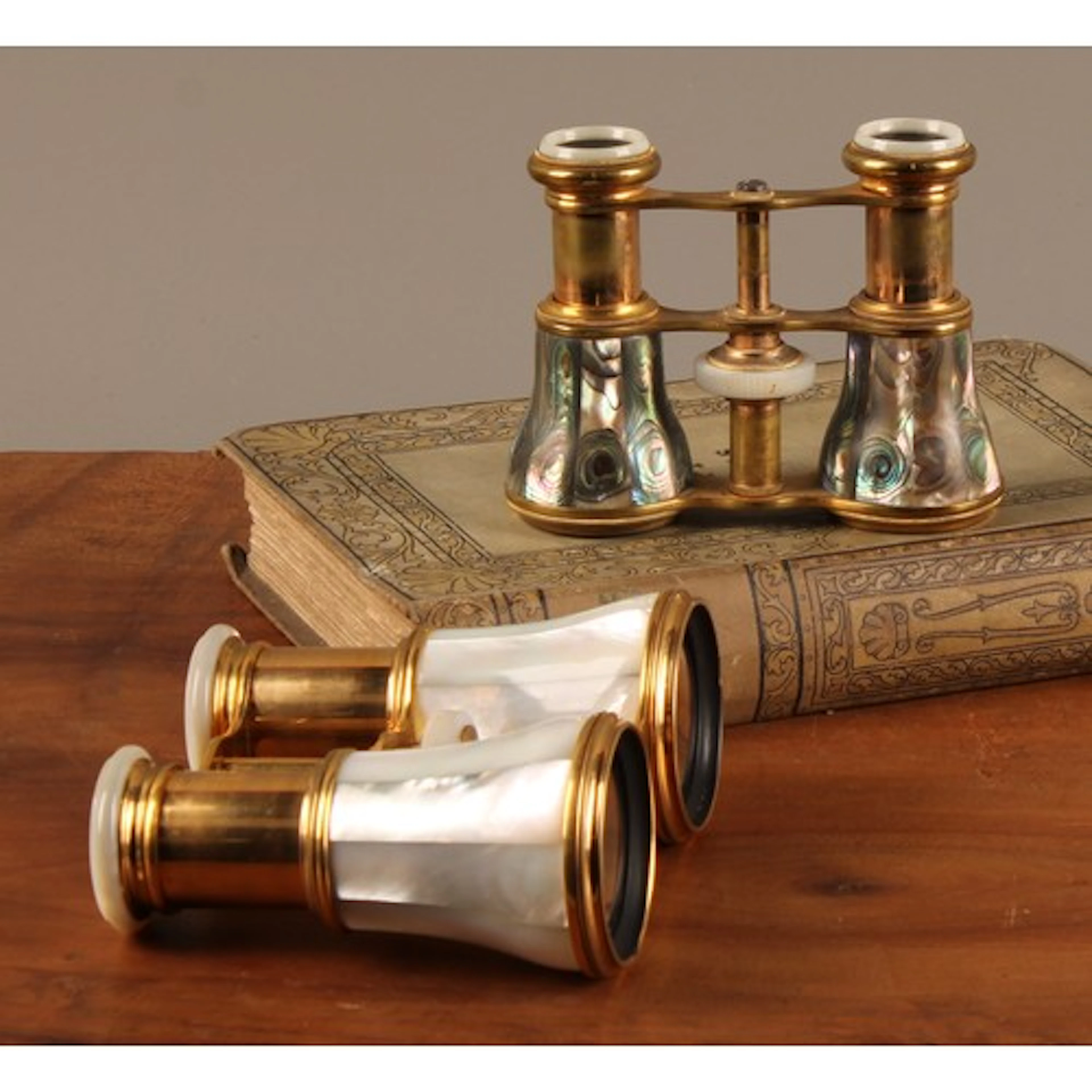 A pair of French gilt metal and abalone shell opera glasses,...