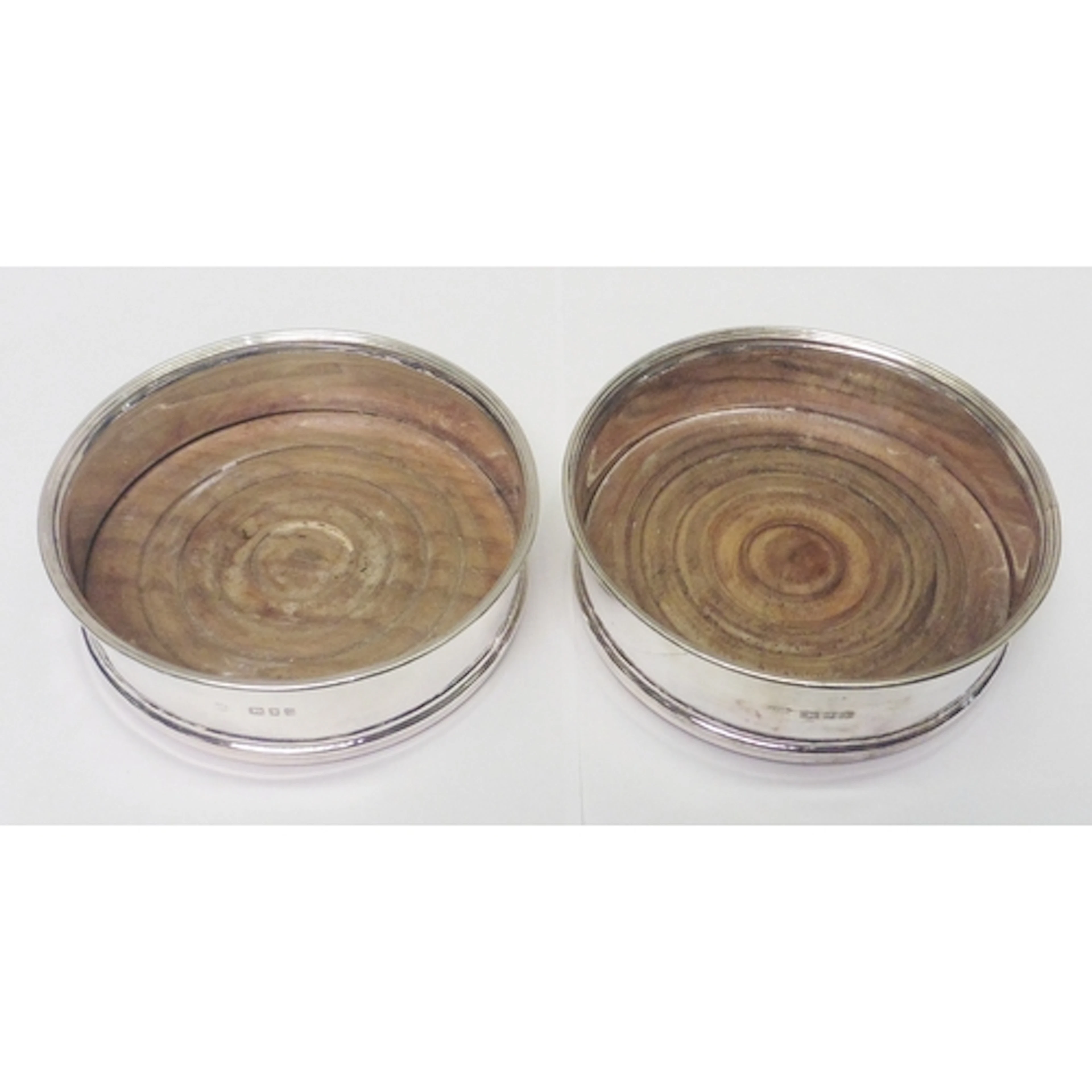 A pair of silver and hardwood coasters, 20th cent. A/F dents...
