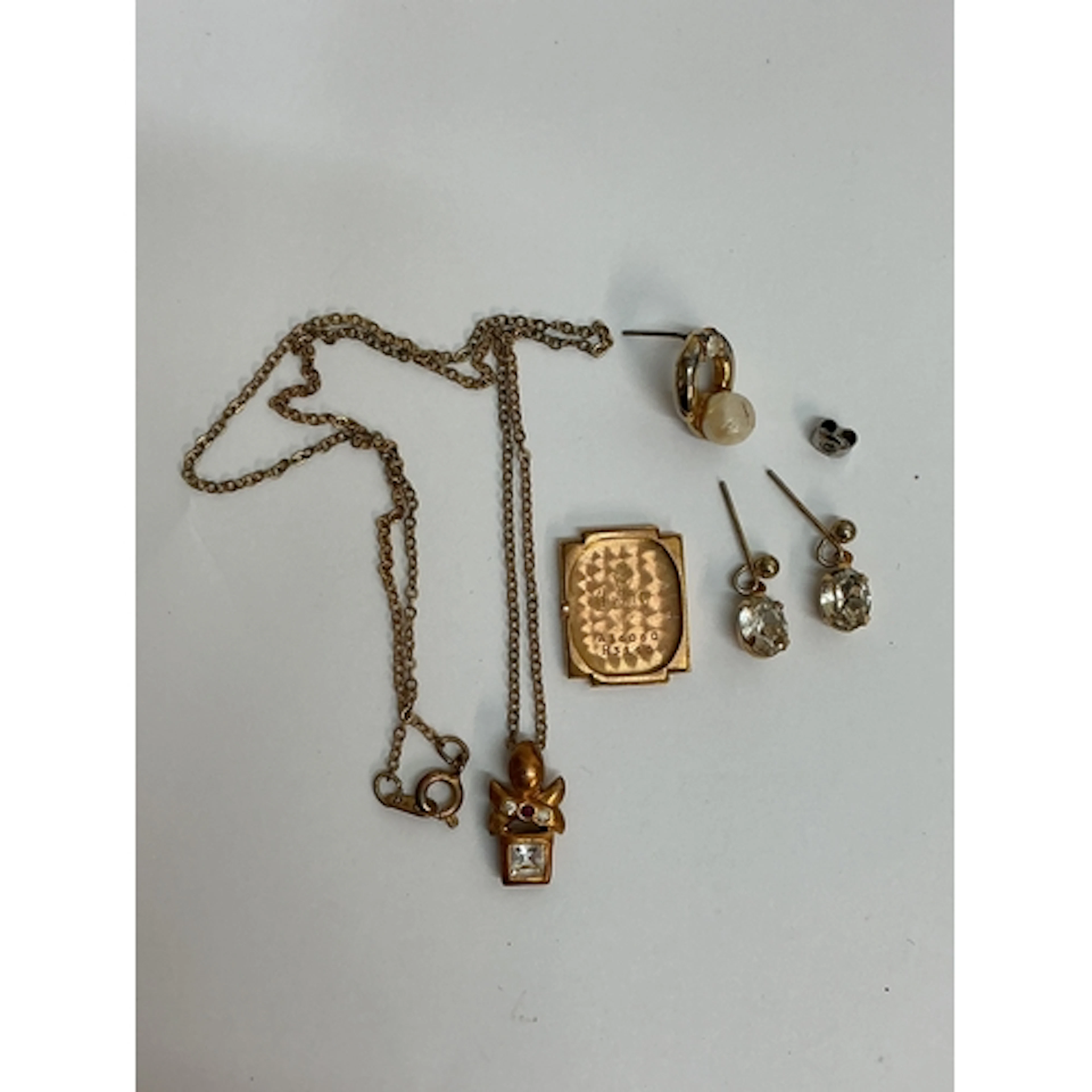 An 18ct gold watch case back plus dress jewellery odds. Appr...
