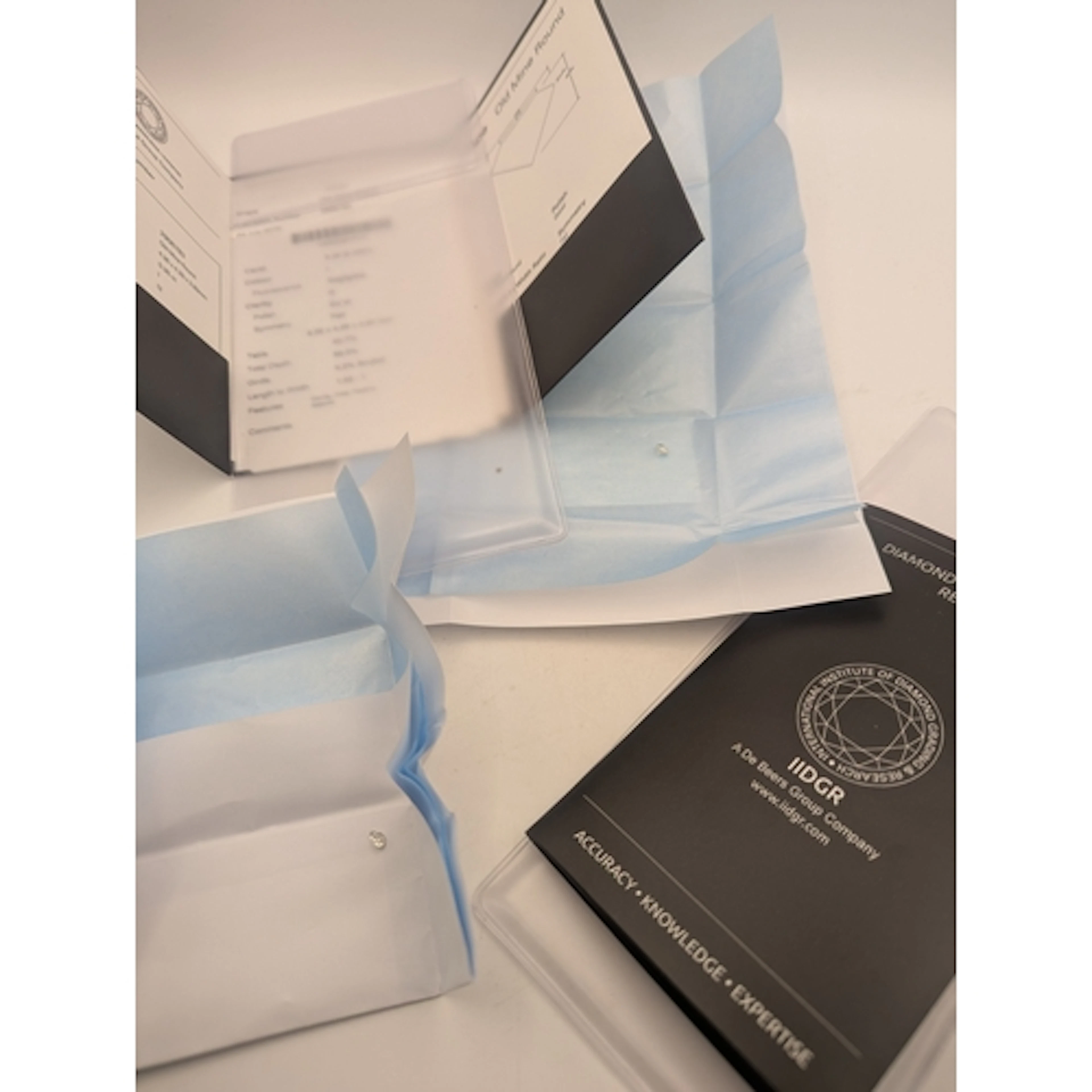 Two diamonds with De Beers Grading reports to include a 0.32...