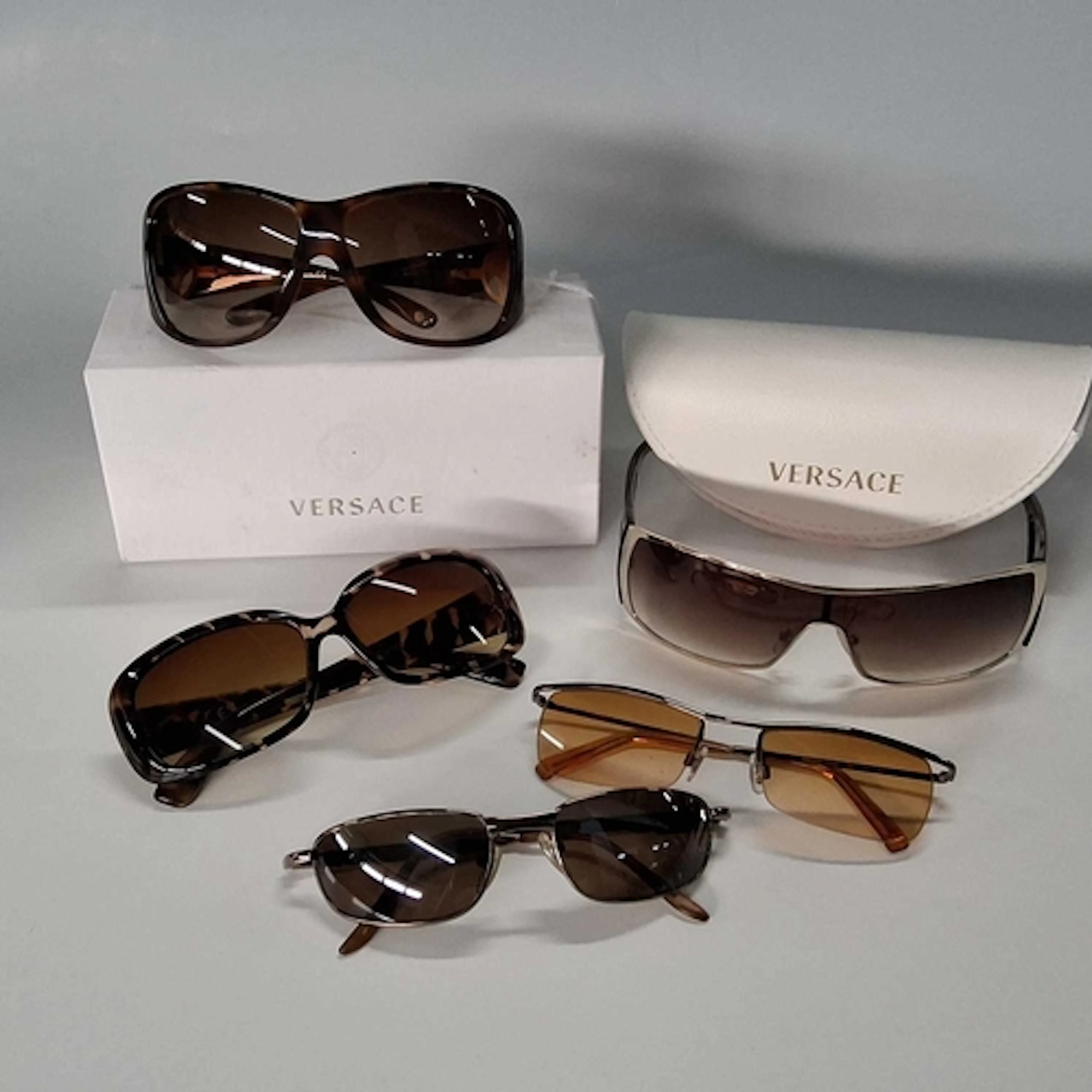 GROUP OF FIVE PAIRS OF SUNGLASSES, to include a pair of Vers...