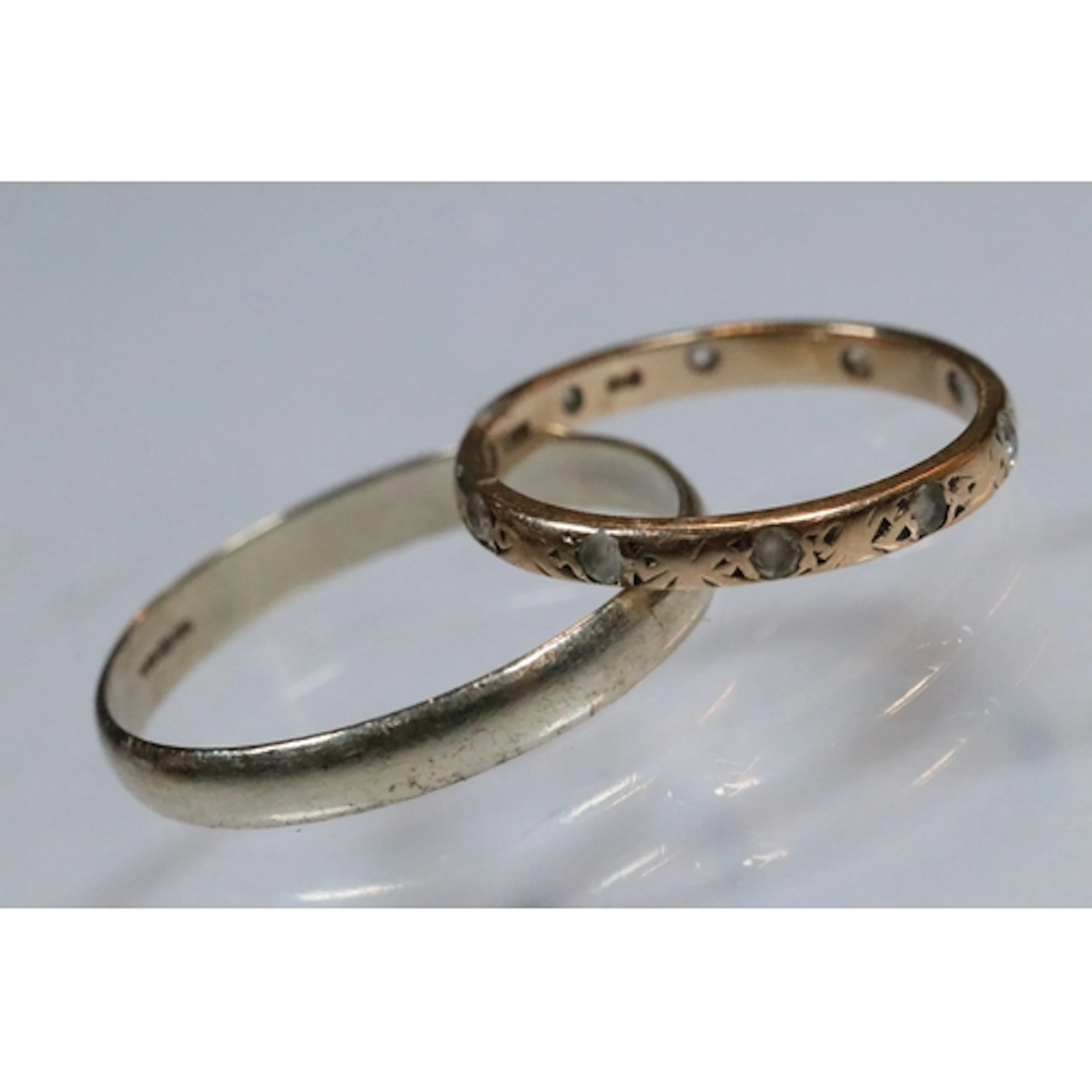 Two 9ct gold rings to include a white gold band ring of plai...