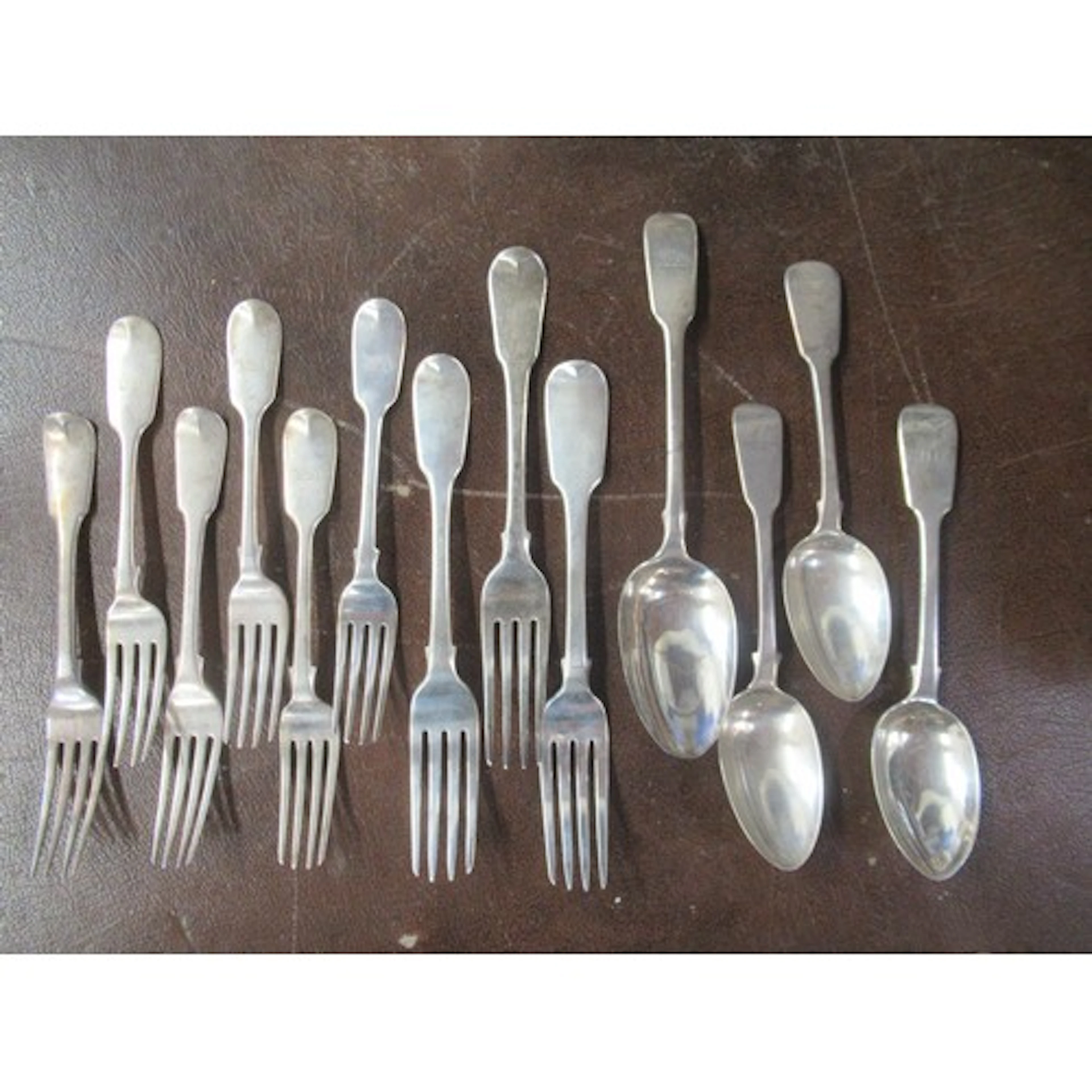 A collection of 19th century silver fiddle pattern flatware,...