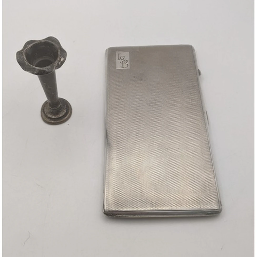 A silver cigarette case, hallmarked Birmingham 1914, having ...