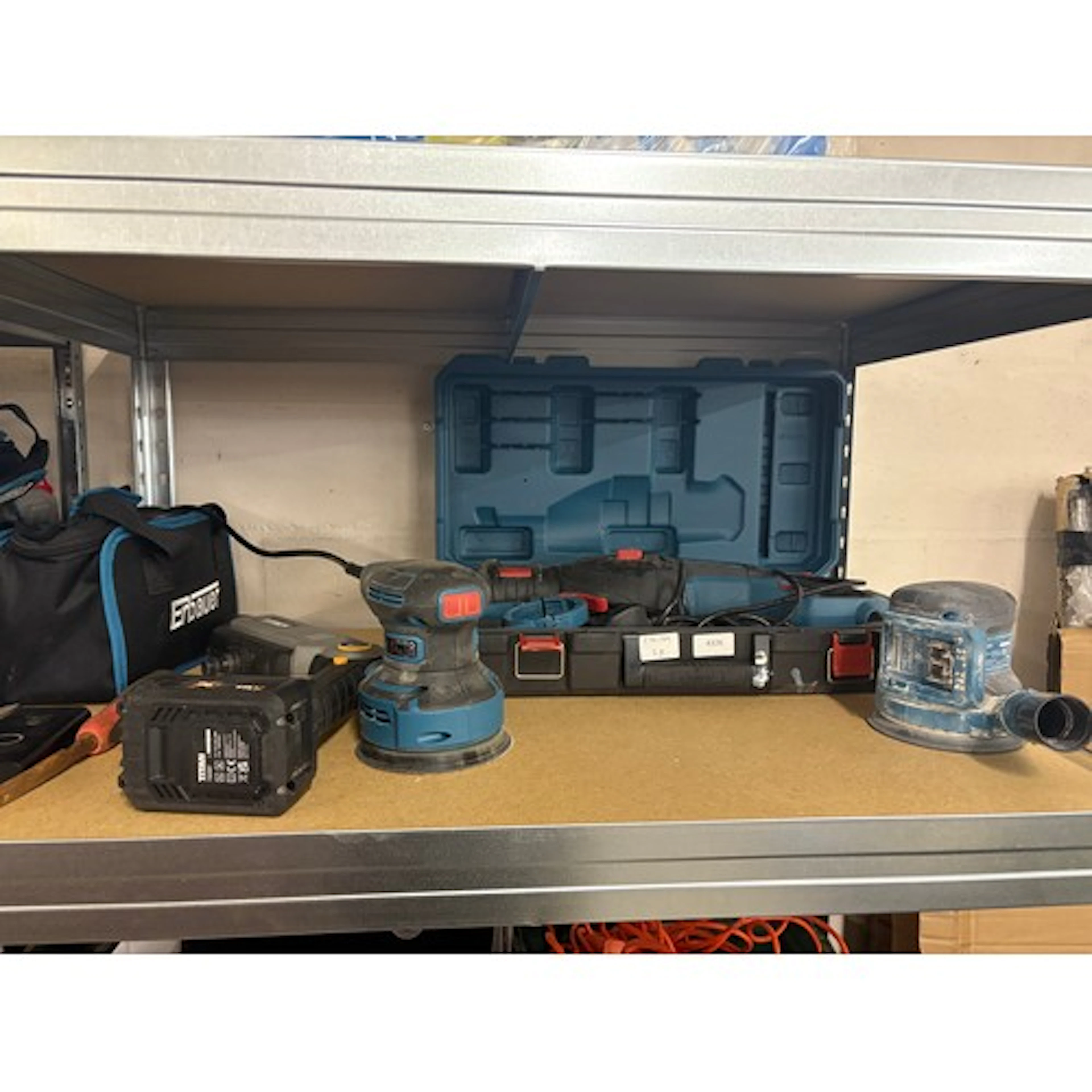 An Erbauer reciprocating saw, two Erbauer sanders and a Tita...