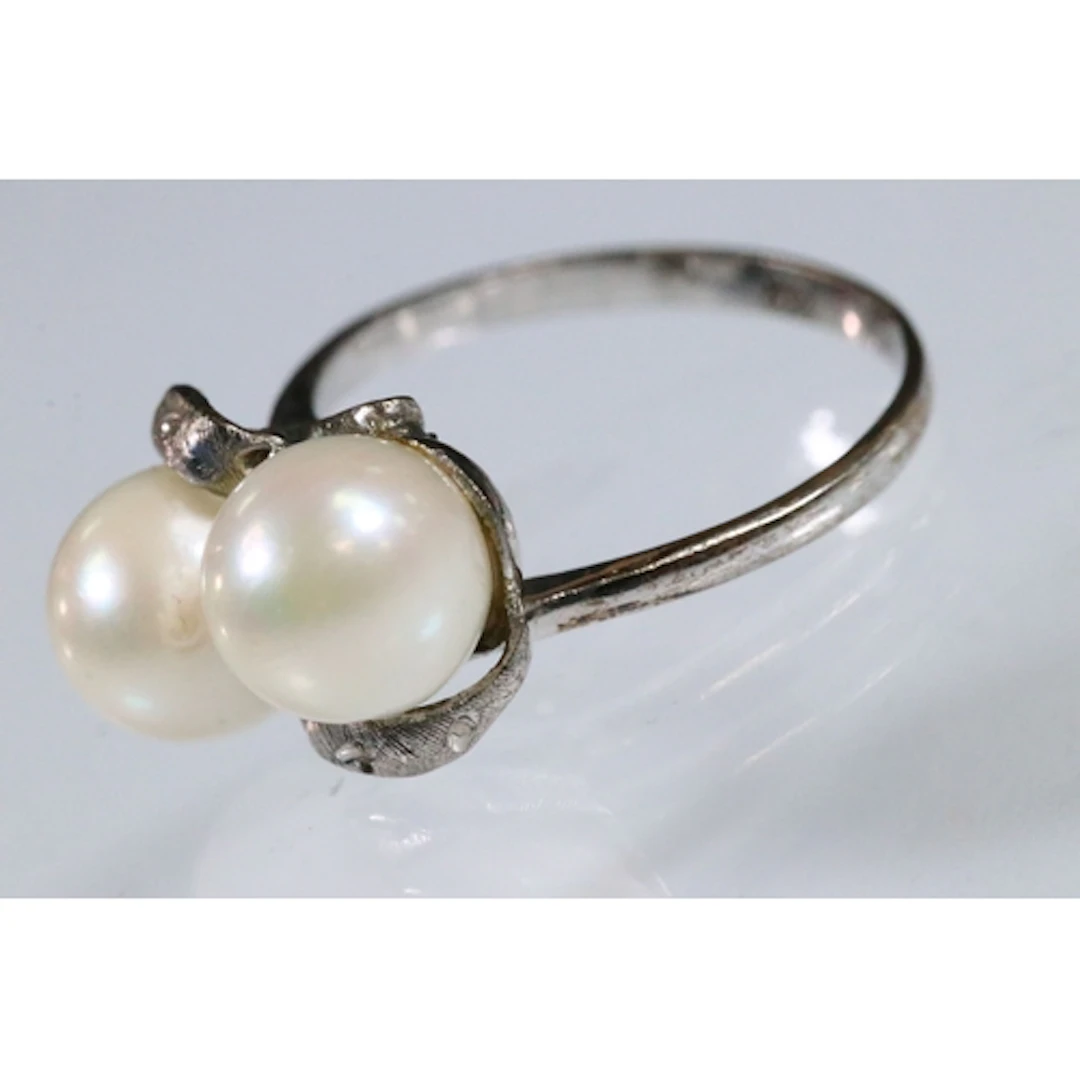 14ct white gold and cultured pearl ring. The ring being set ...