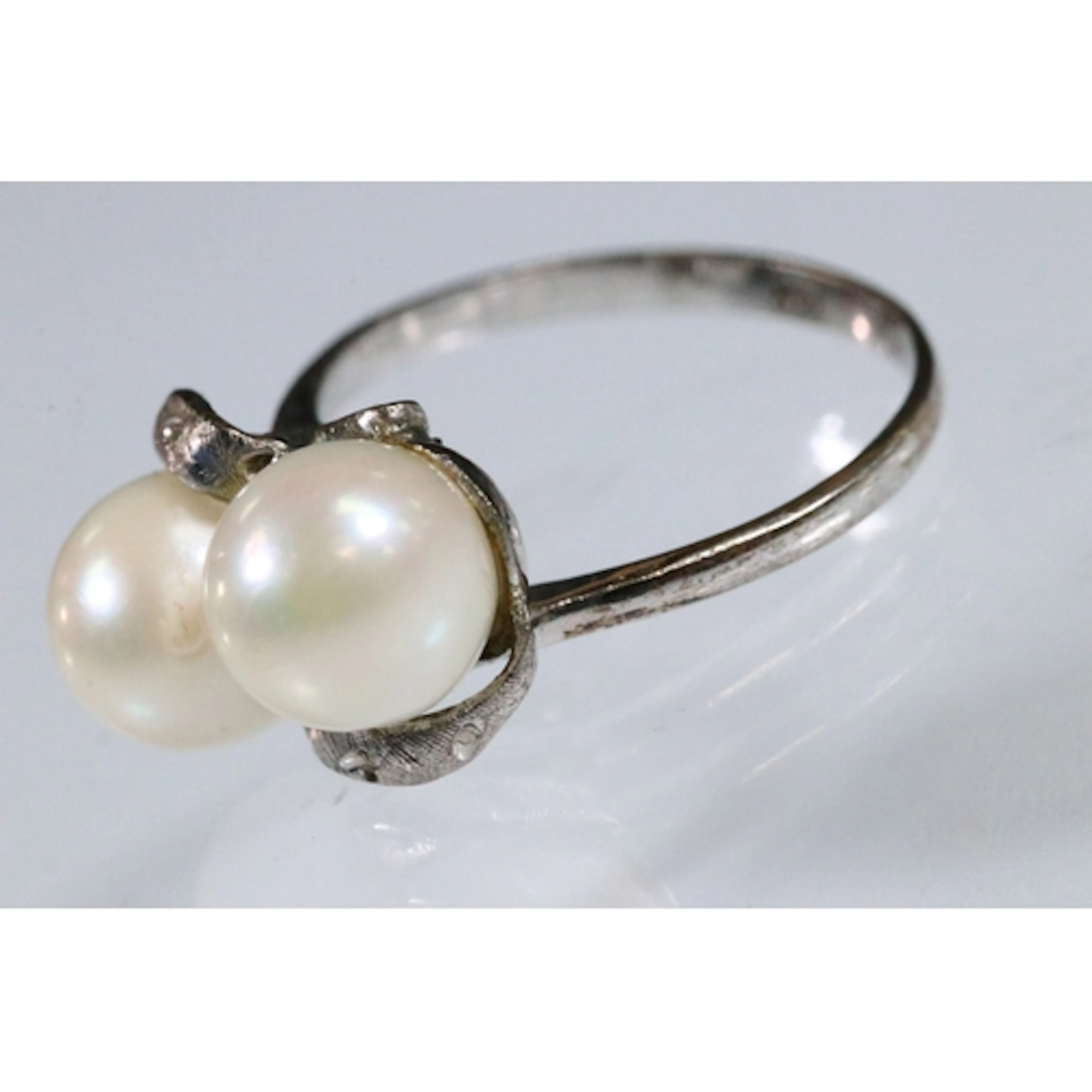 14ct white gold and cultured pearl ring. The ring being set ...