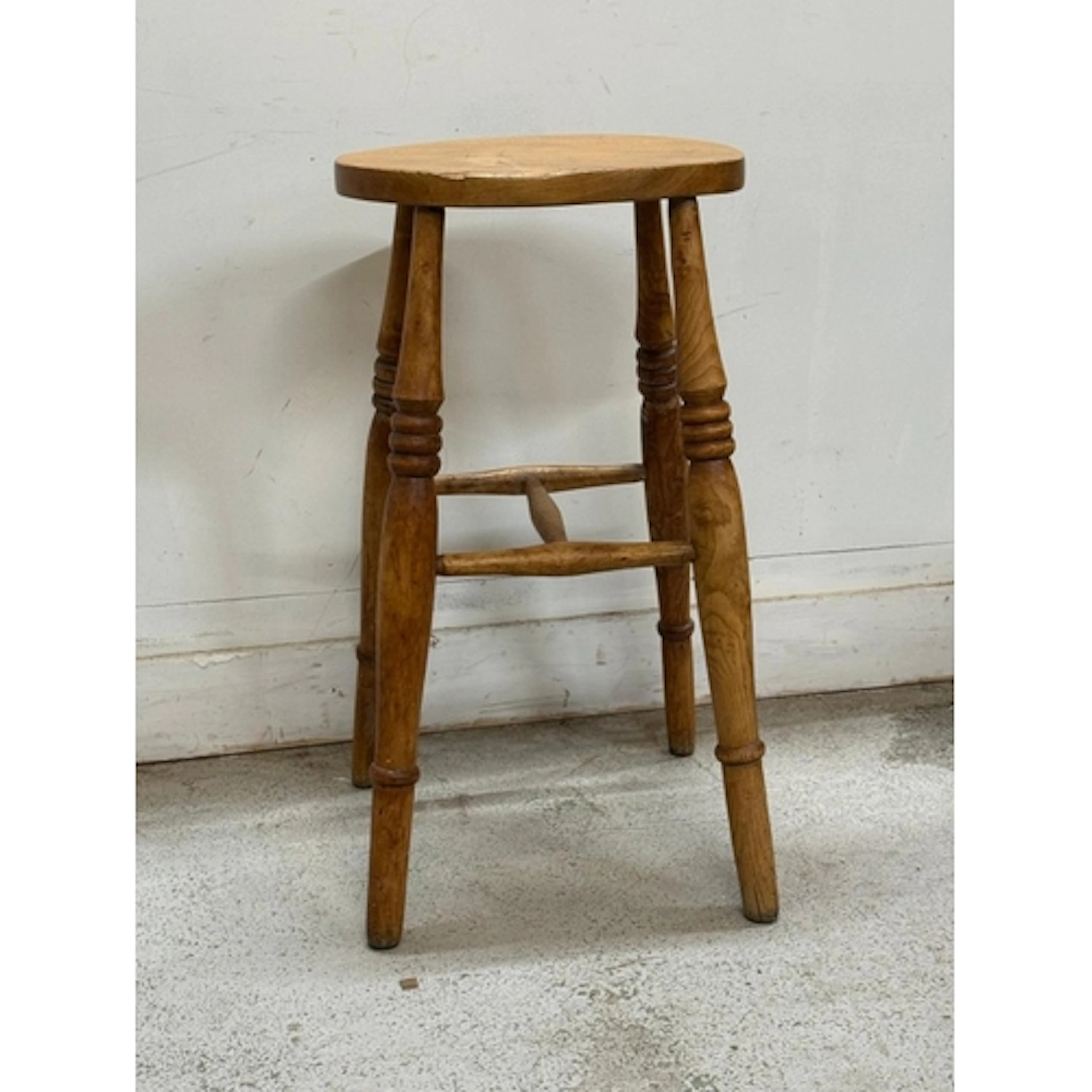 A pine farmhouse style stool on turned legs