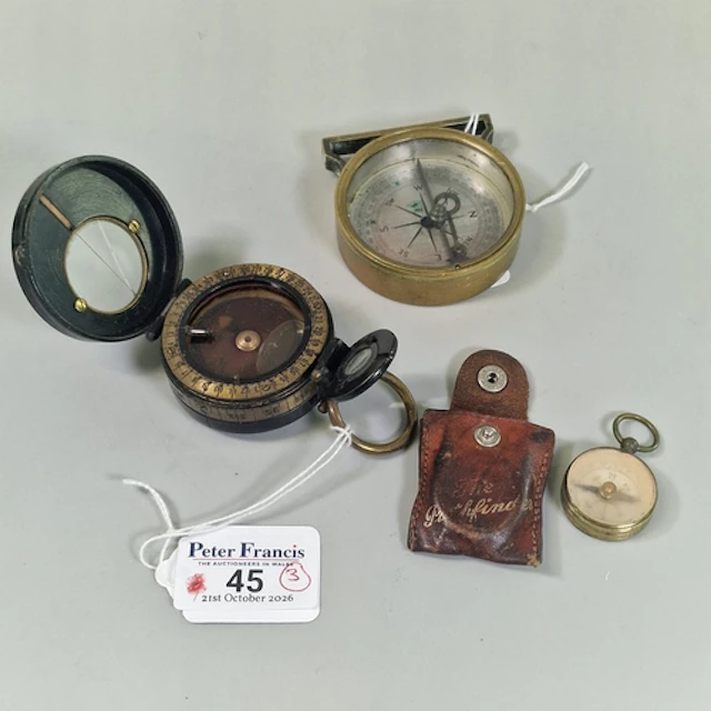 Three brass-cased compasses, comprising a WWI Barker & Son p...