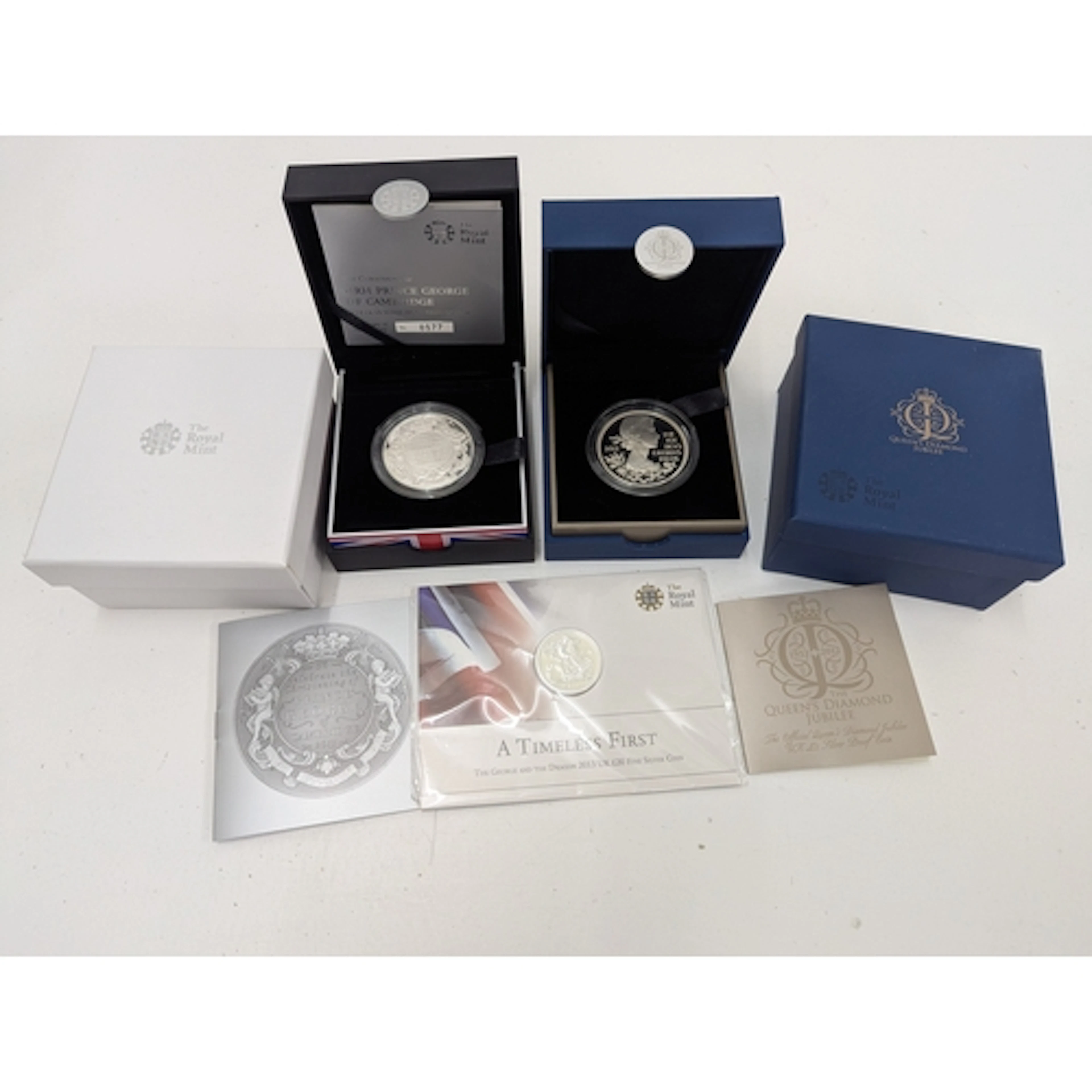 Two silver proof £5 coins to include Queen's Diamond Jubilee...
