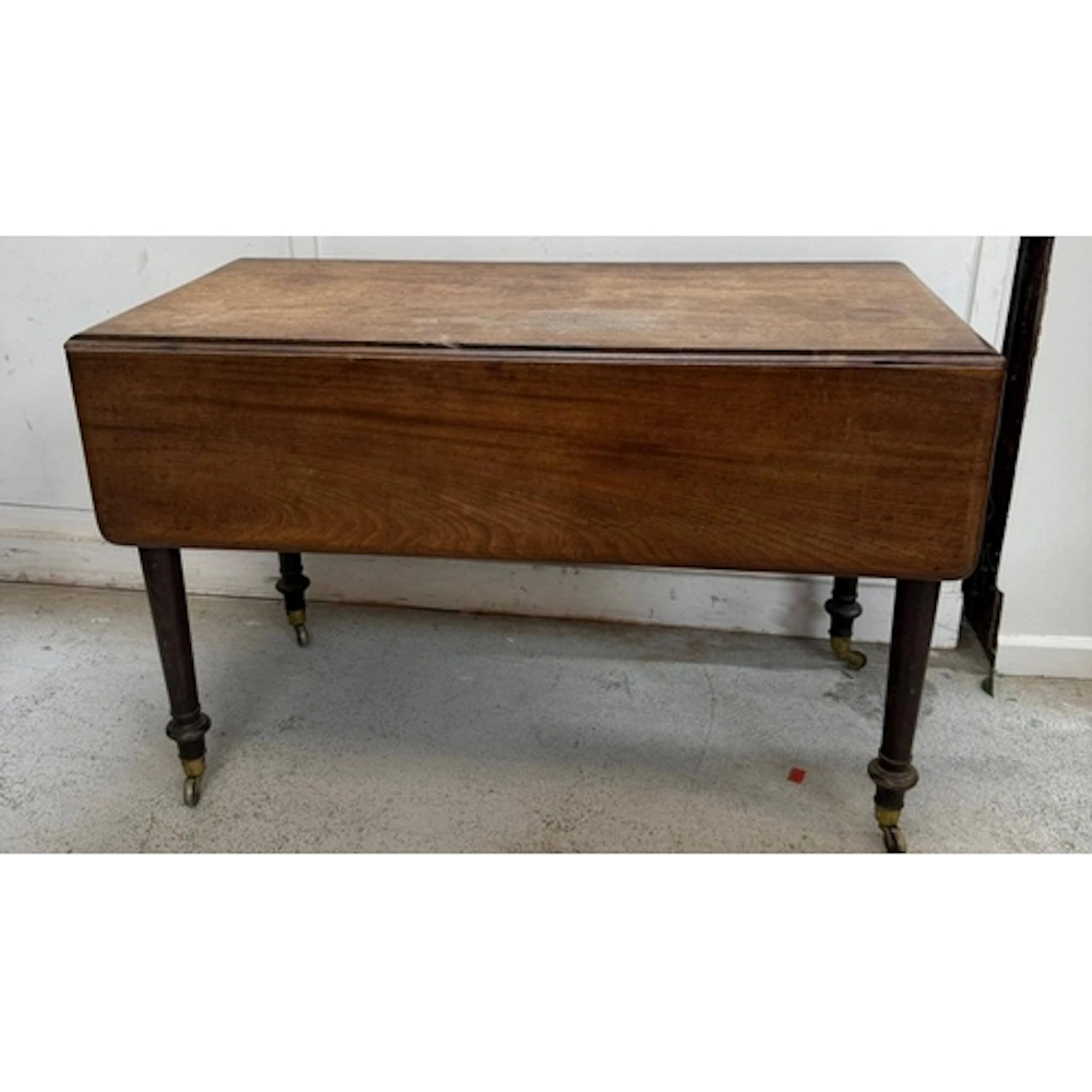 A Georgian mahogany drop leaf side table on turned legs and ...