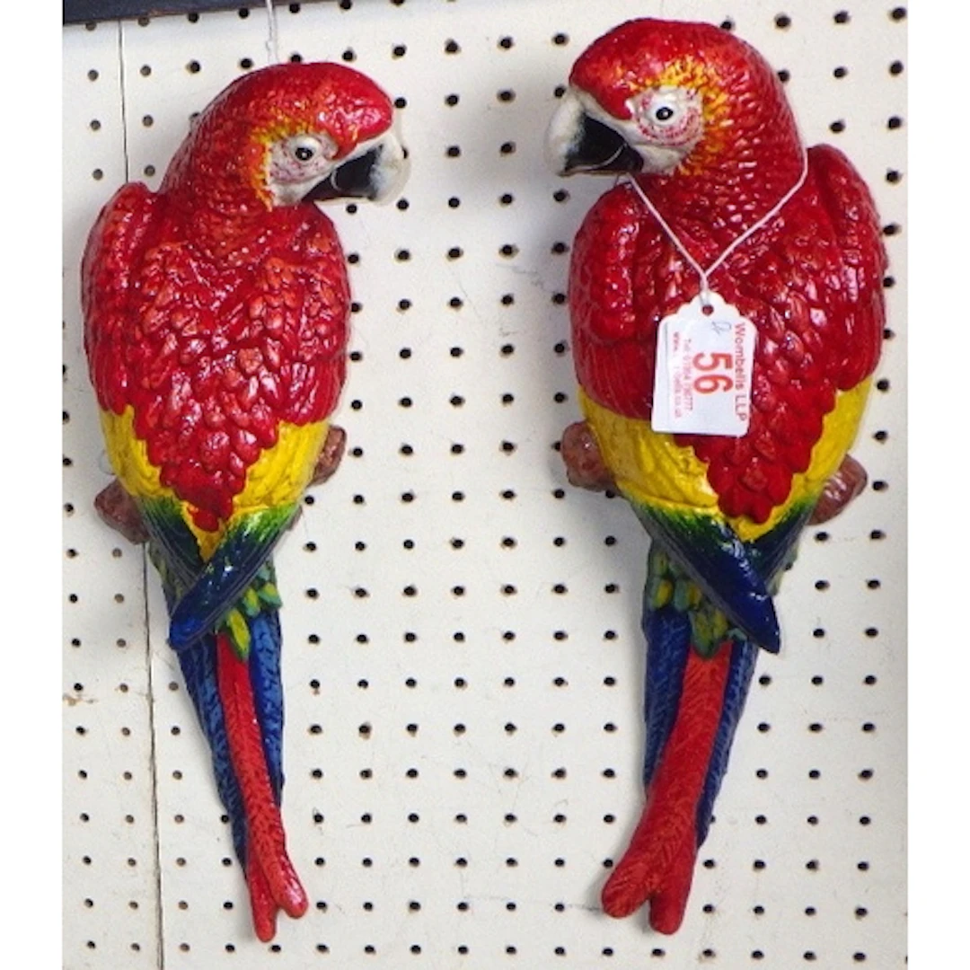 A pair of wall mounted cast parrots