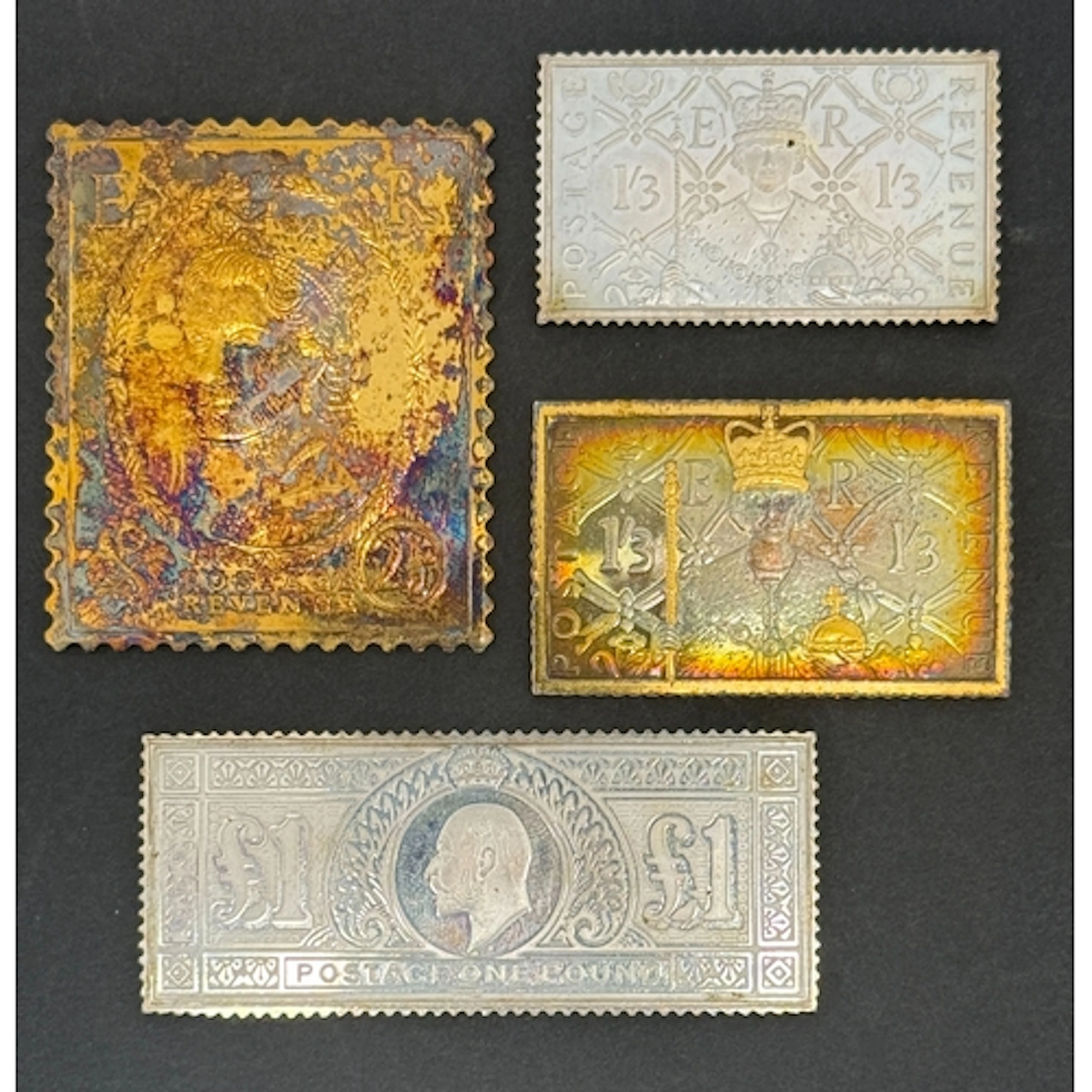 A group of four silver stamp ingots, each depicting a Britis...