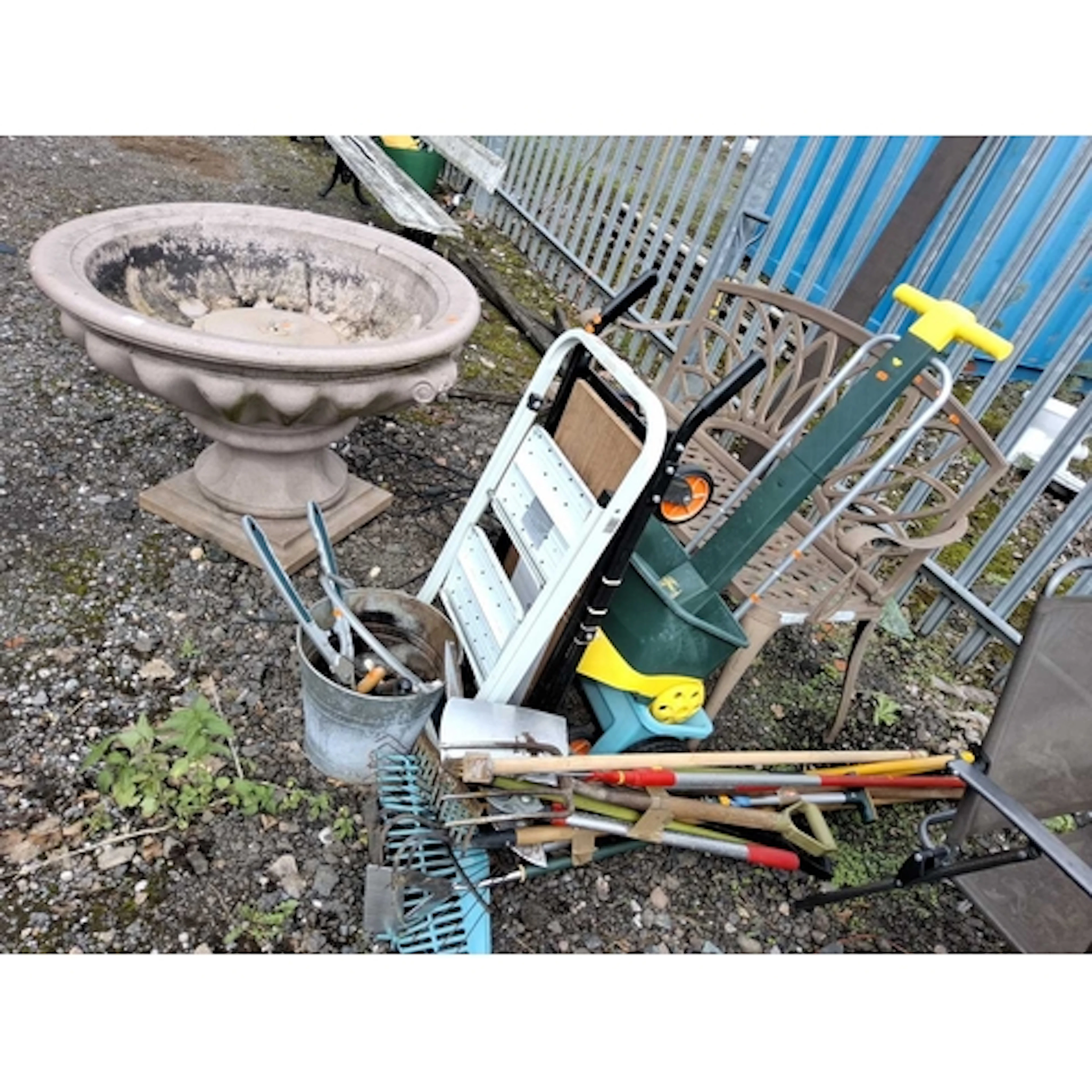 A CAST ALUMINIUM GARDEN BENCH, GARDEN TOOLS AND A PLASTIC WA...