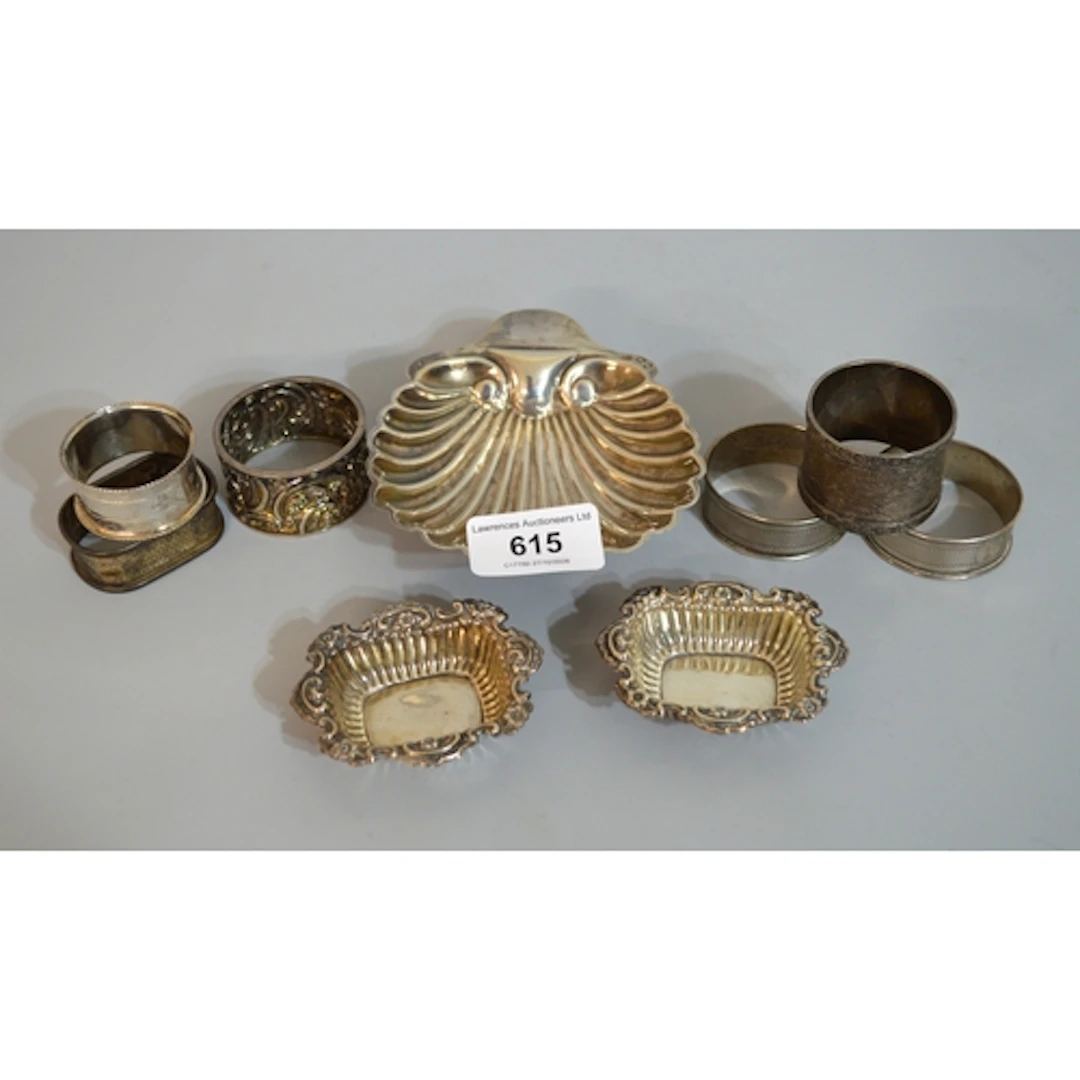 Silver shell form butter dish, six various silver napkin rin...