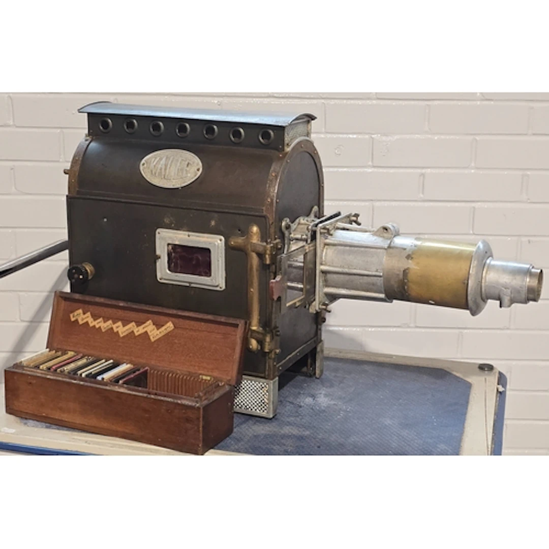 A vintage Kalee cinema slide projector c/w a box of extra sl...