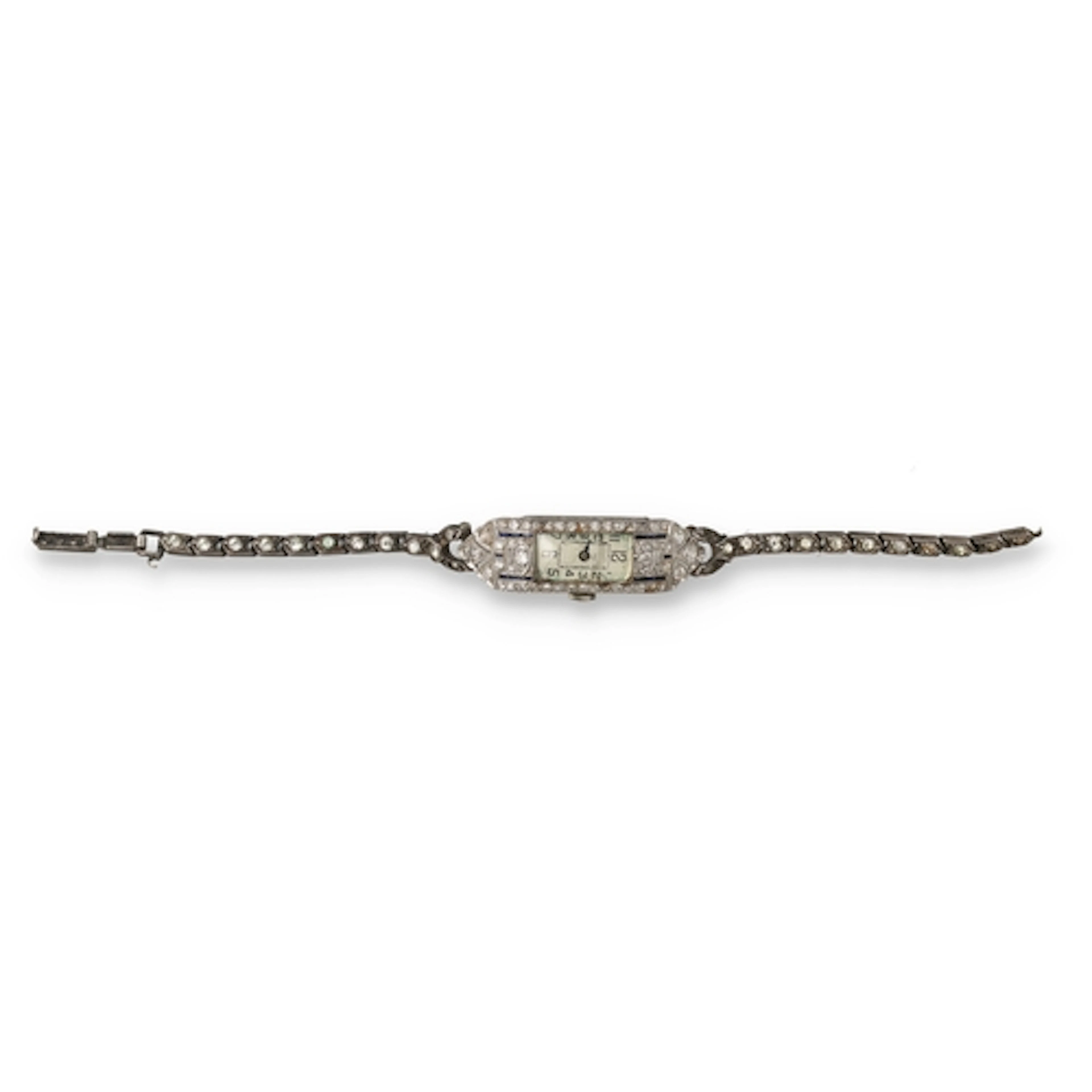 AN ART DECO PLATINUM DIAMOND AND BLUE ENAMEL COCKTAIL WATCH ...