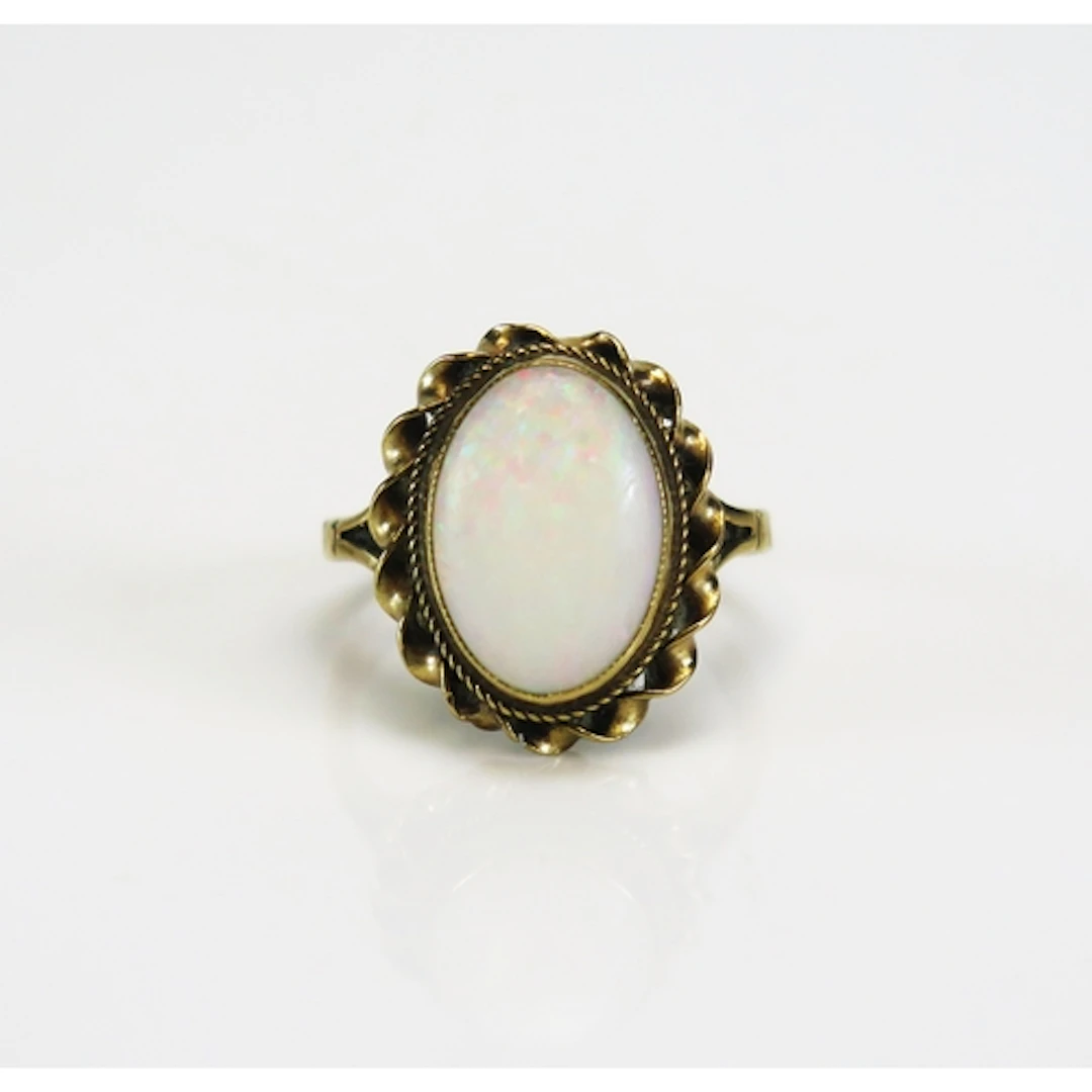 A 9ct gold opal dress ring in a rope twist setting, c. 13.5 ...