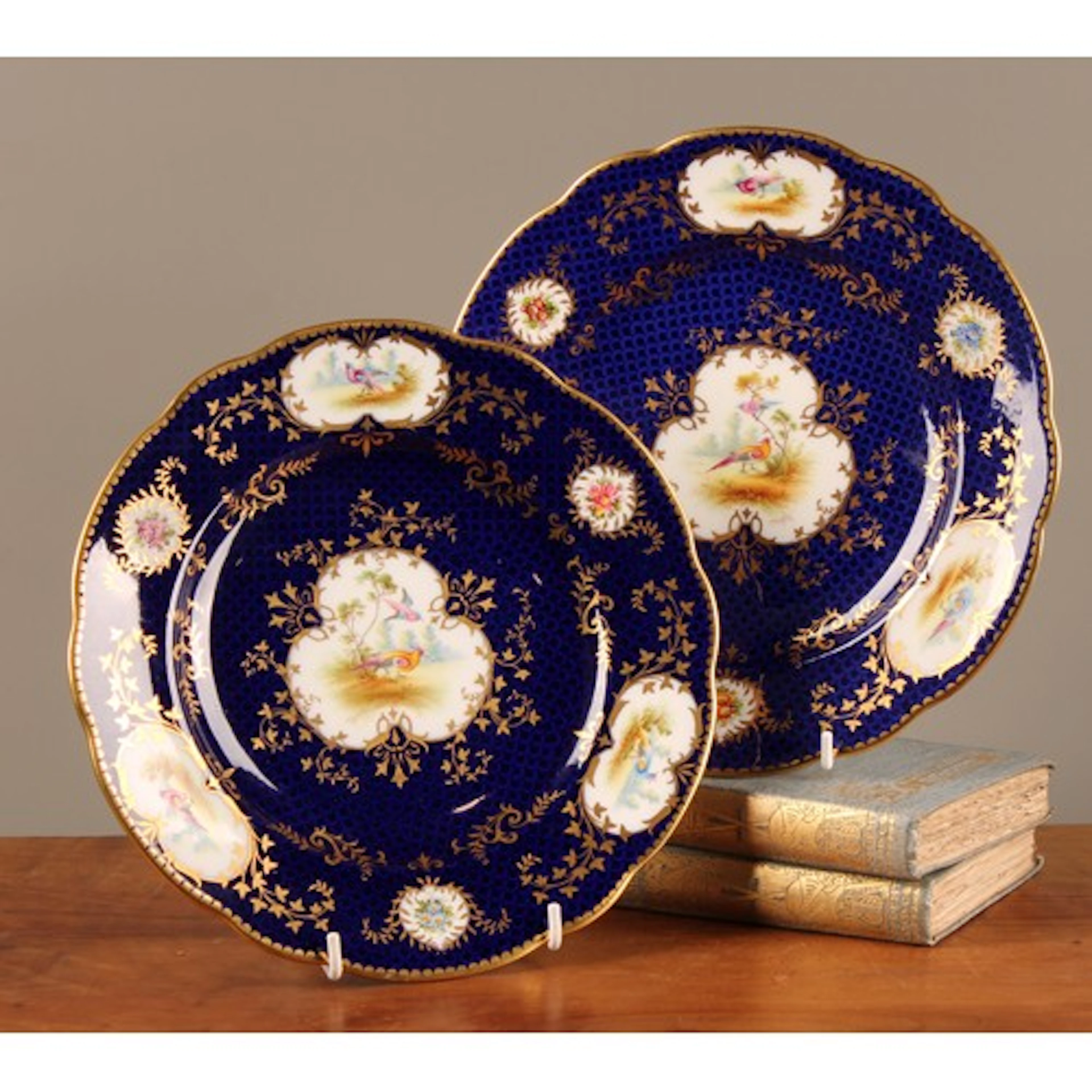 A pair of Coalport shaped circular plates, painted by Percy ...