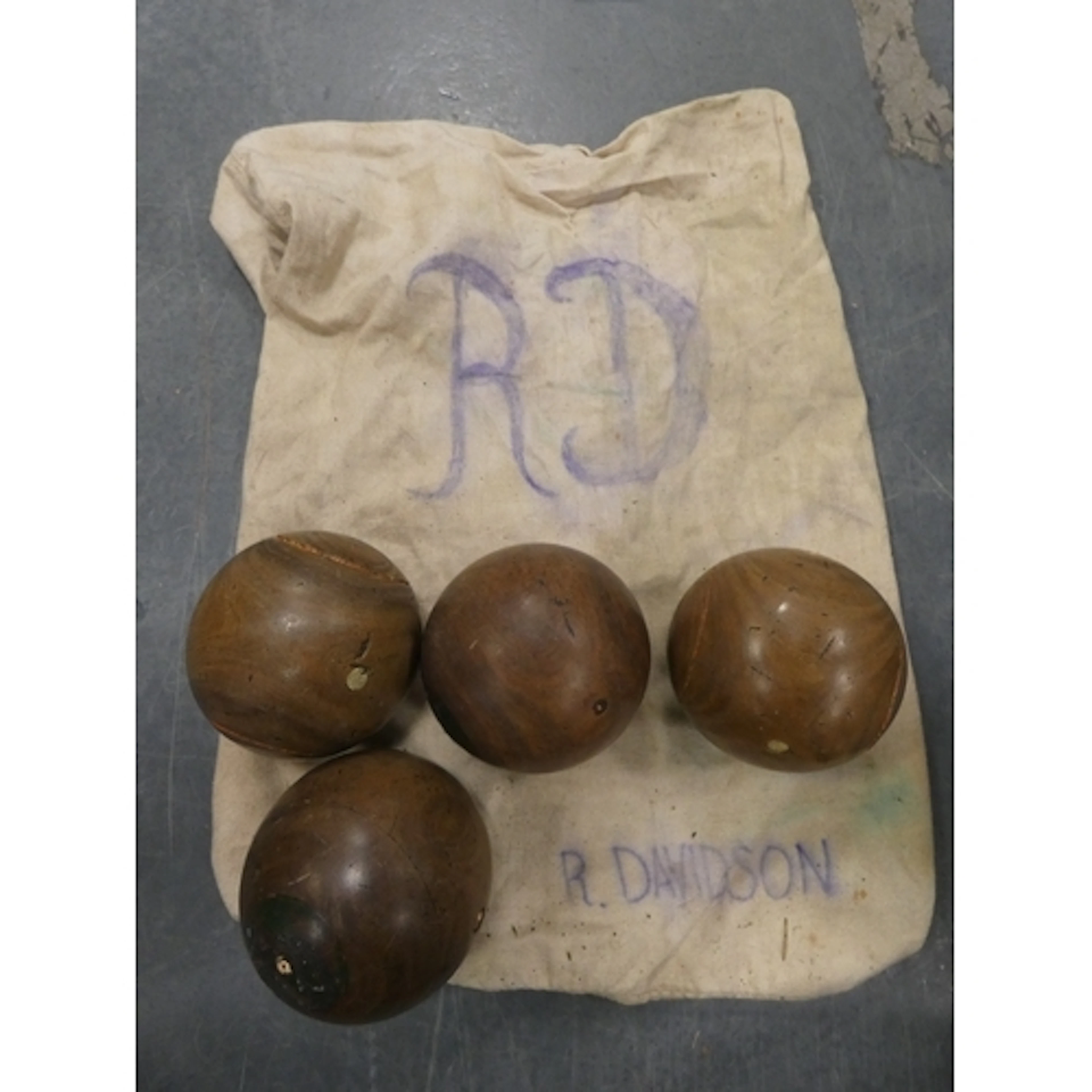 Four antique wooden carpet bowls, stamped 'Lawrie, Glasgow' ...