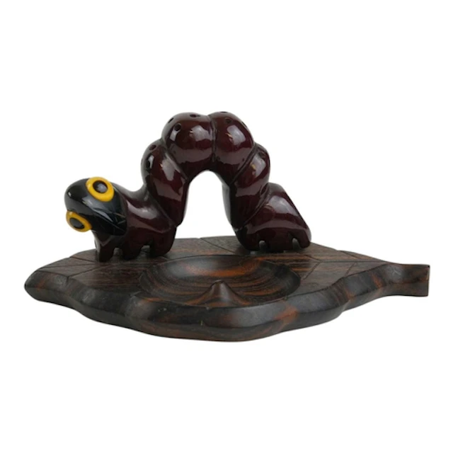 A 'YZ' caterpillar or 'Loopa' match striker and ashtray. Cir...
