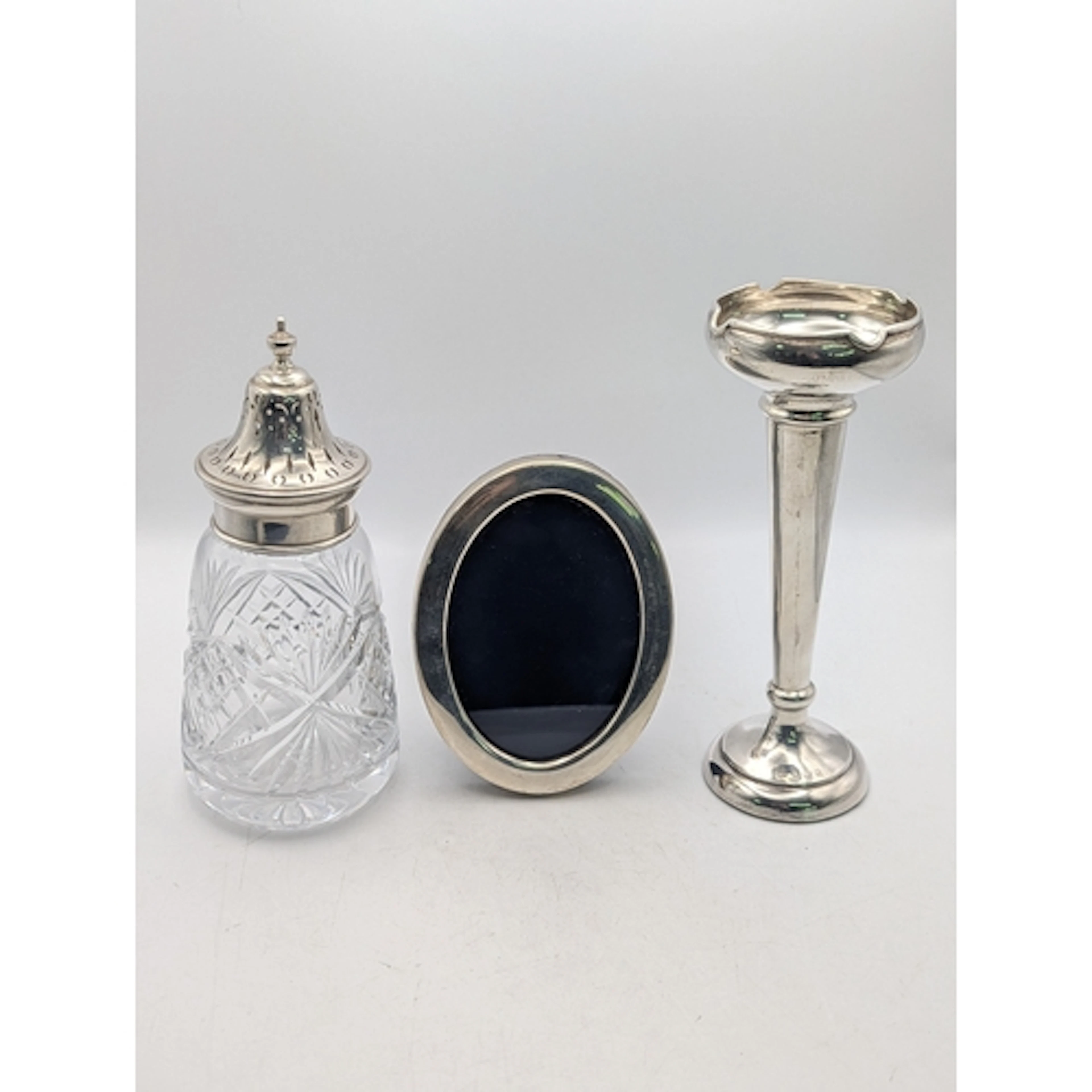 Mixed silver items to include a trumpet vase, having a weigh...