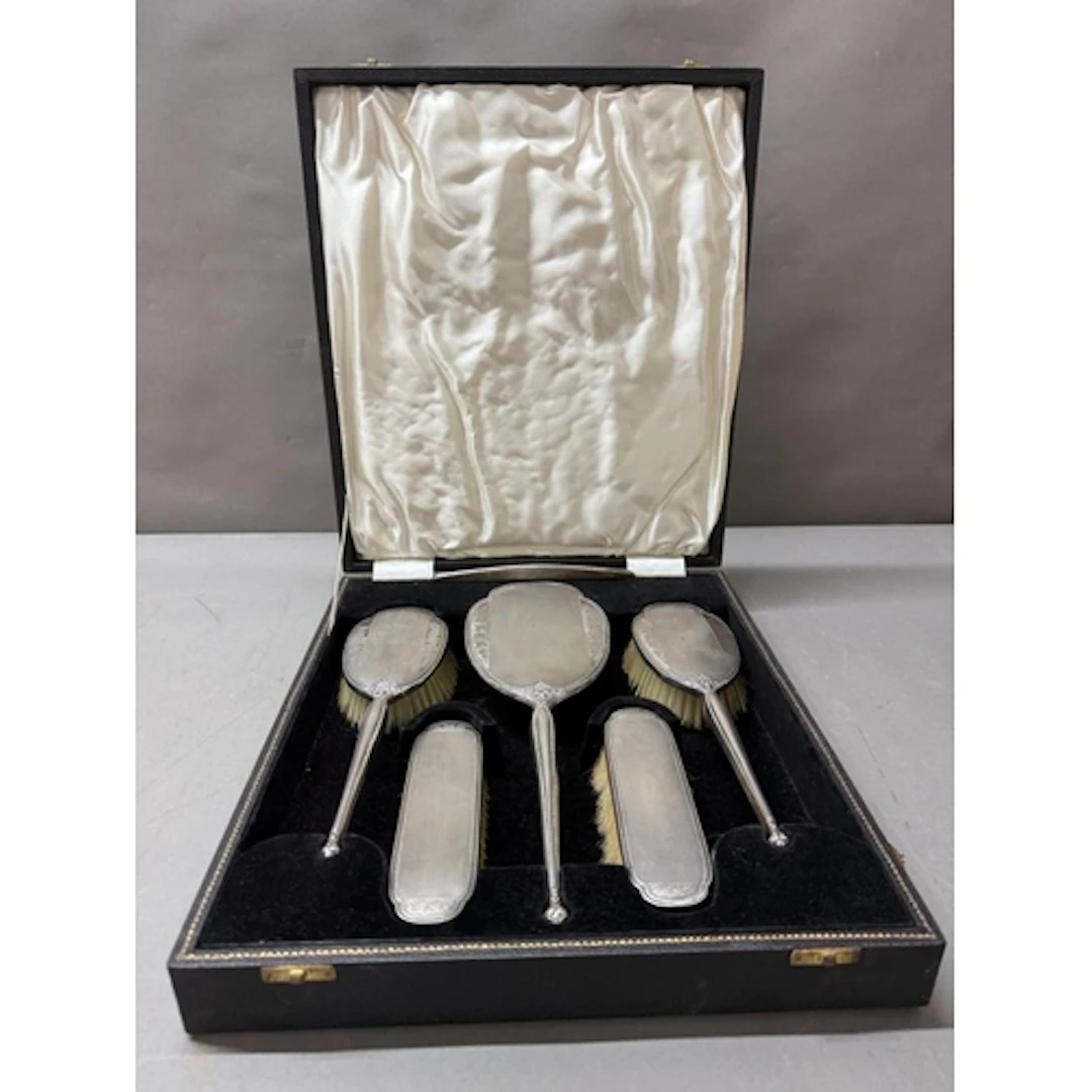 A cased silver vanity set hallmarked for Birmingham 1959 mak...