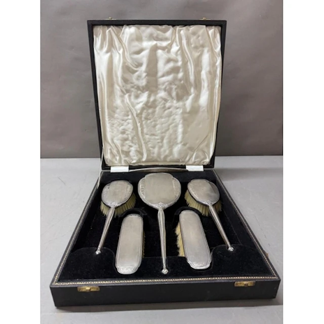 A cased silver vanity set hallmarked for Birmingham 1959 mak...
