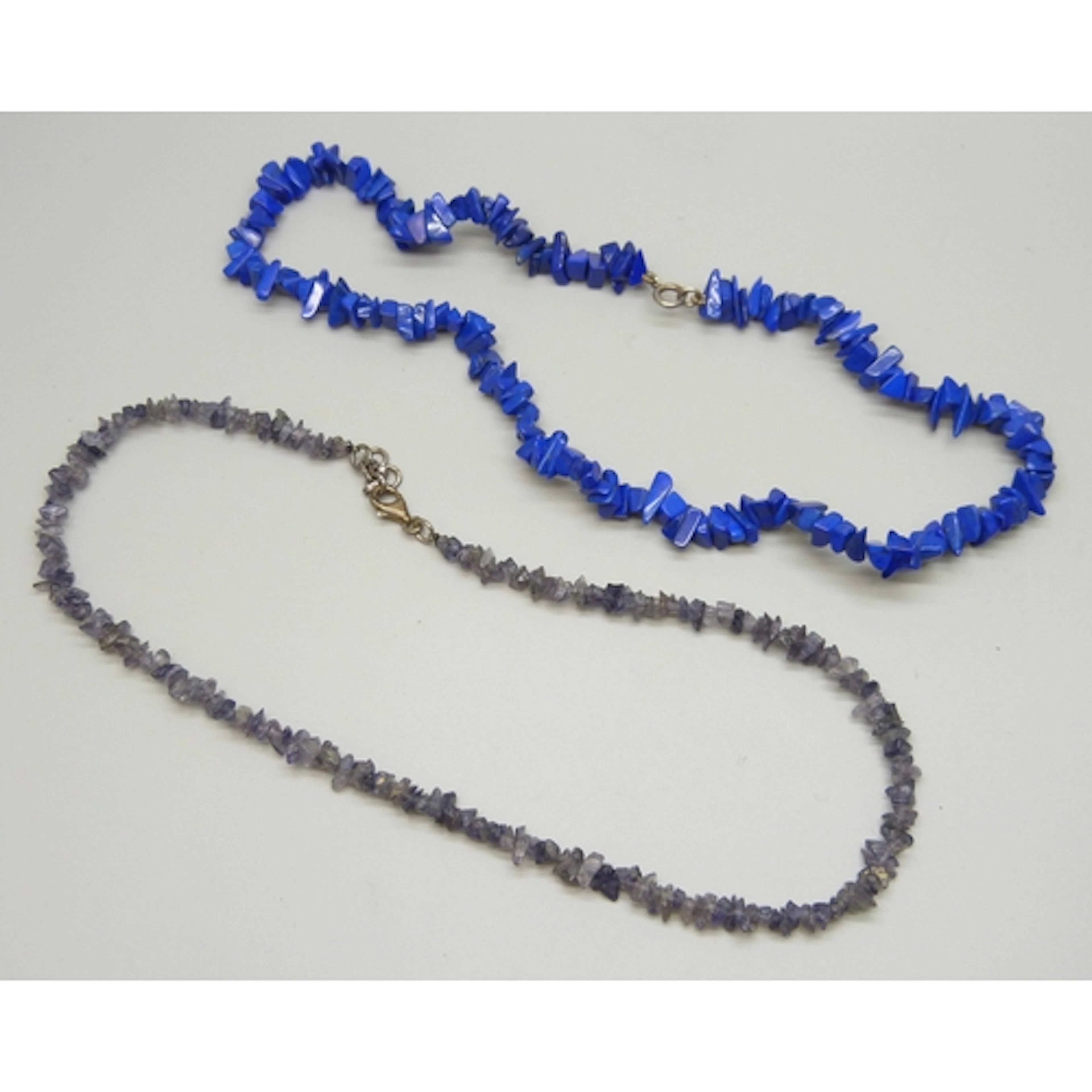 A lapis lazuli necklace with a silver clasp, and a possibly ...