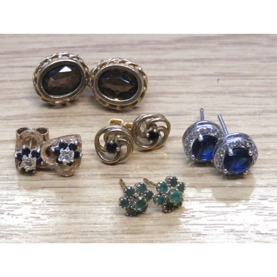 Four pairs of 9ct gold earrings set with various stones, tog...