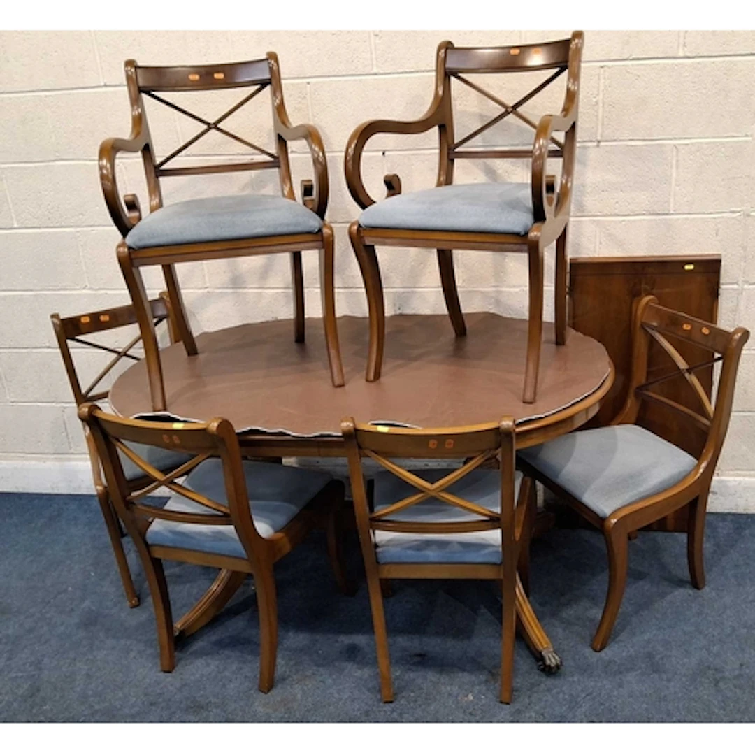 A REPRODUCTION YEW WOOD OVAL EXTENDING DINING TABLE, raised ...