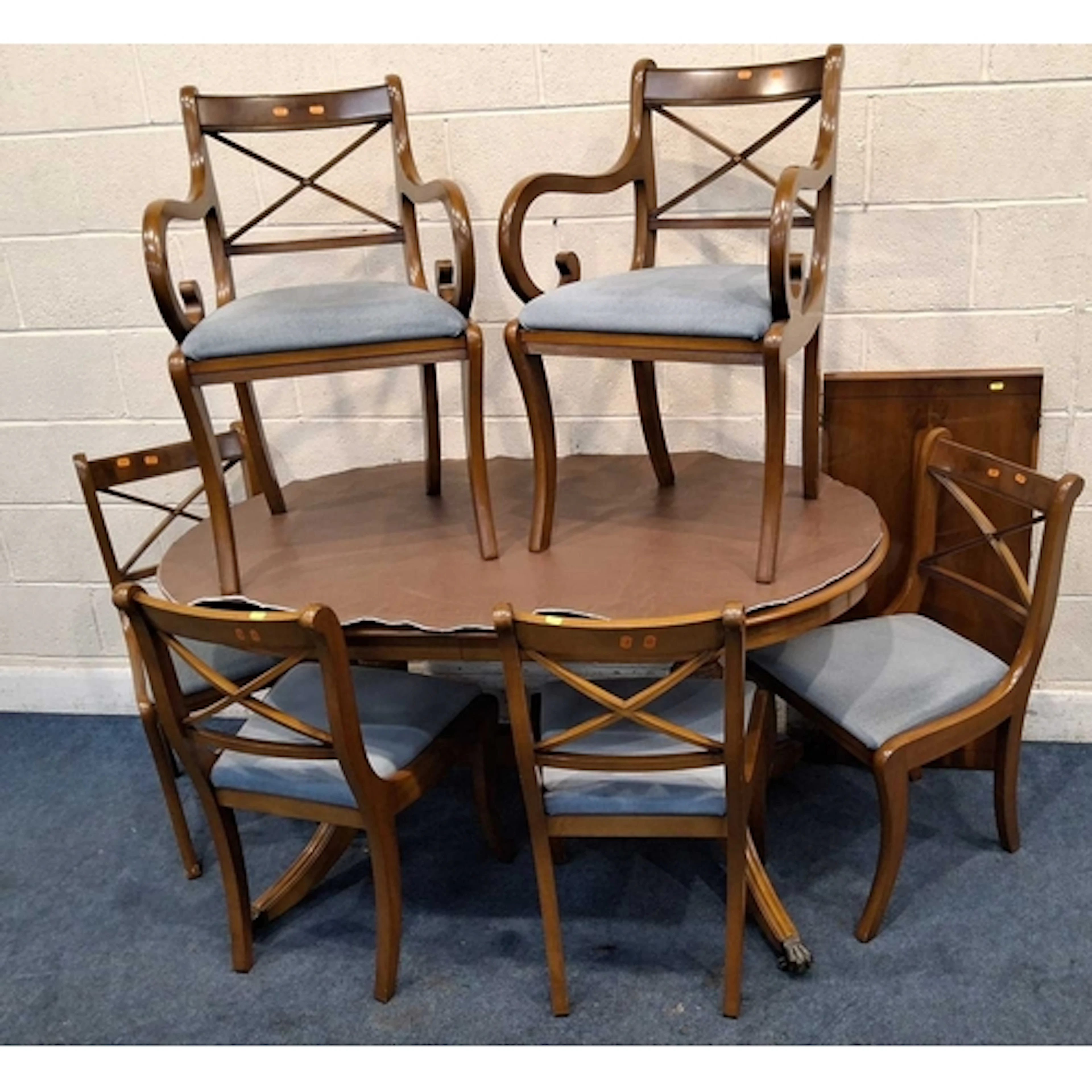 A REPRODUCTION YEW WOOD OVAL EXTENDING DINING TABLE, raised ...