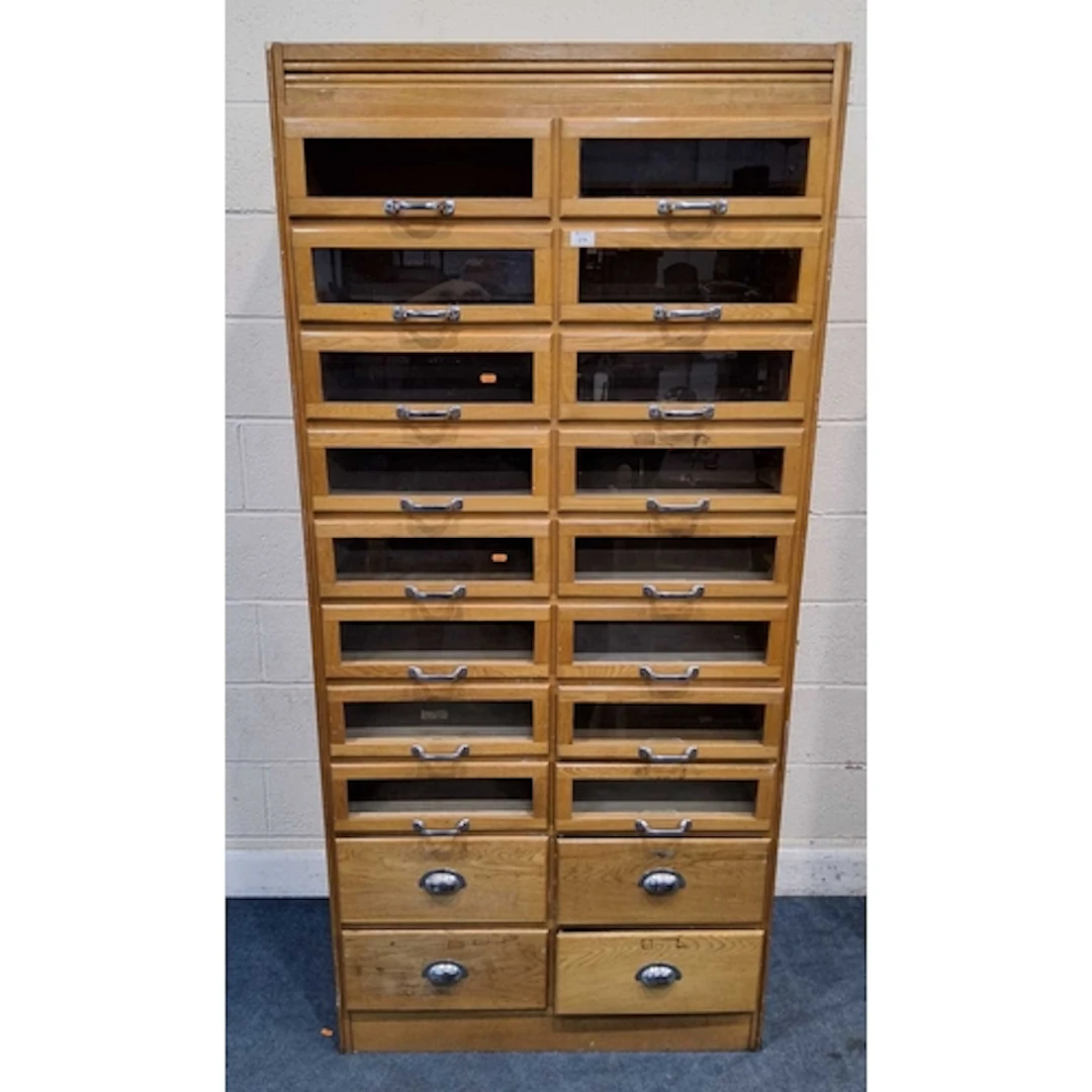 AN EARLY 20TH CENTURY OAK HABERDASHERY CABINET, fitted with ...