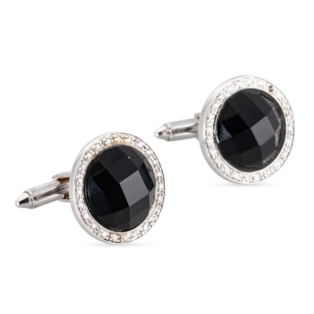 A PAIR OF ONYX AND DIAMOND SET CUFFLINKS, the mixed cut onyx...