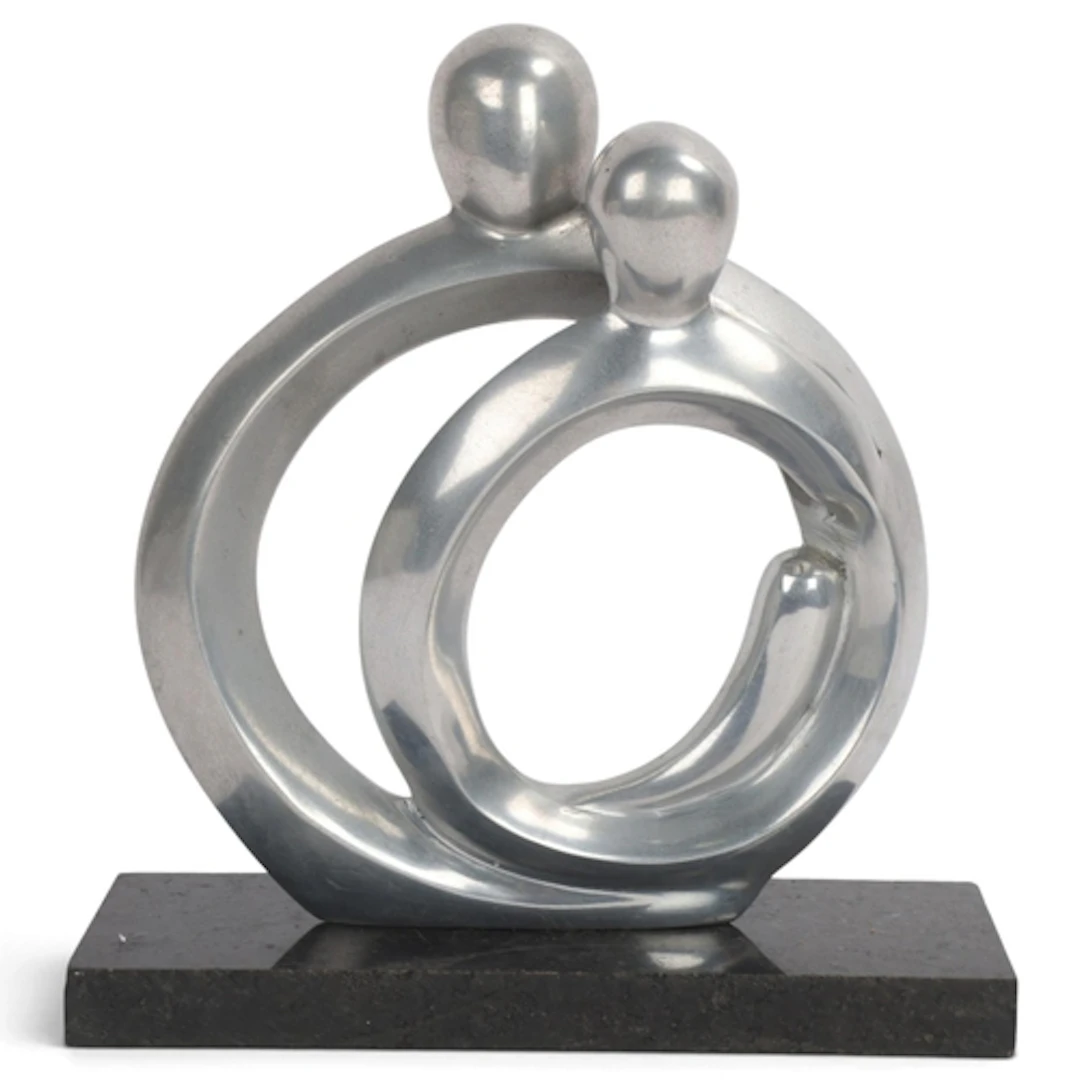 A modernist aluminium sculpture of two figures, on polished...